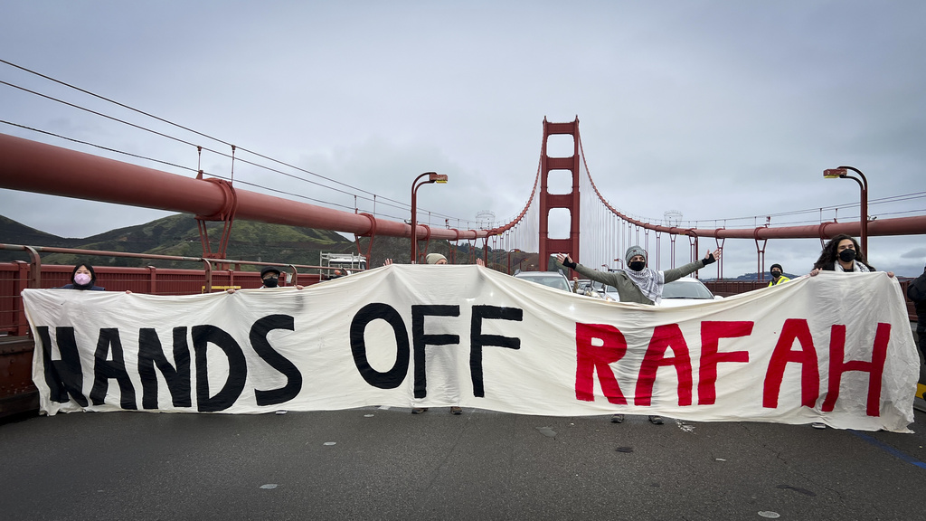 People hold a banner reading &quot;HANDS OFF RAFAH&quot; on the Golden Gate Bridge.