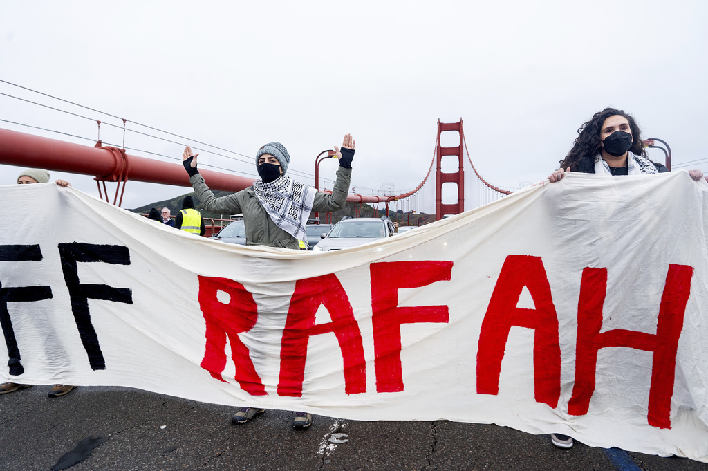 Demonstrators hold a banner while blocking commute traffic on the Golden Gate Bridge on Wednesday.