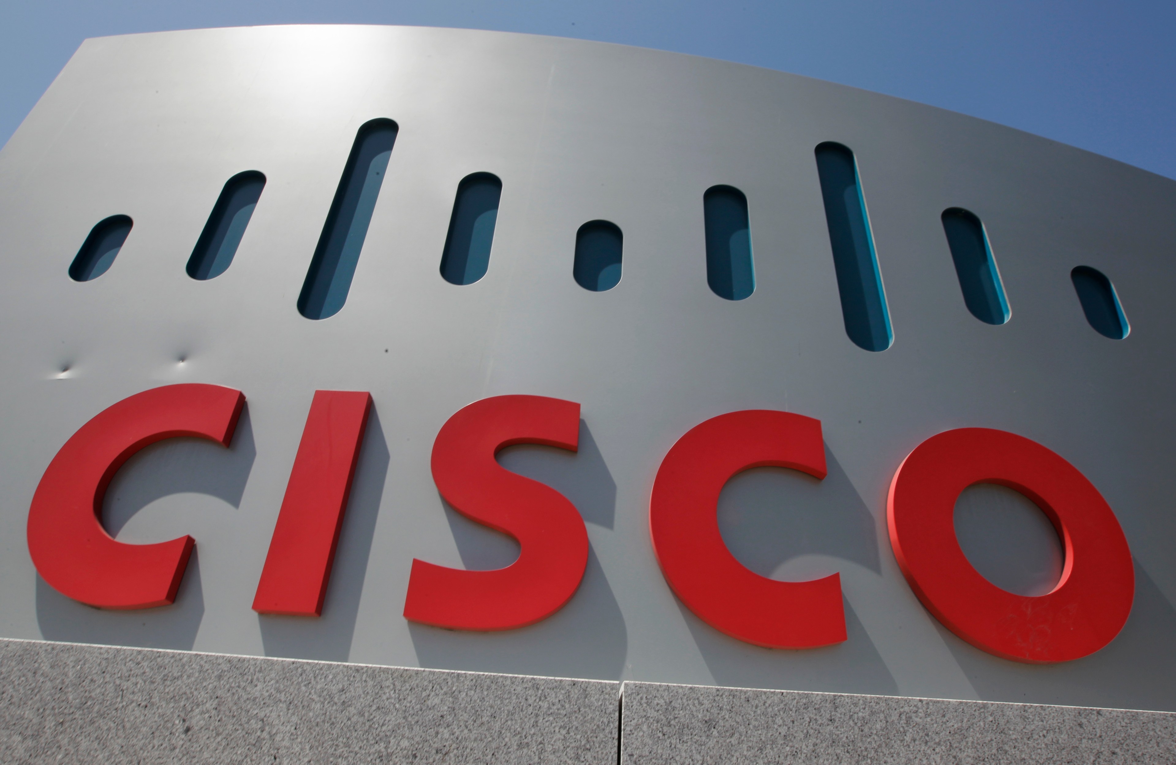 A gray and red sign for Cisco outside the company headquarters