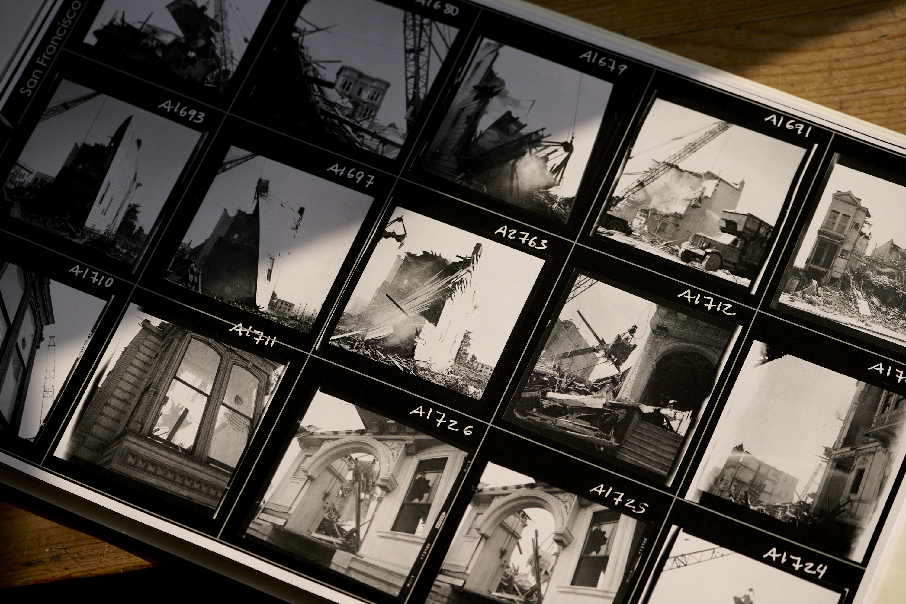 Contact sheet with black-and-white photos of urban destruction, possibly from a disaster or demolition.