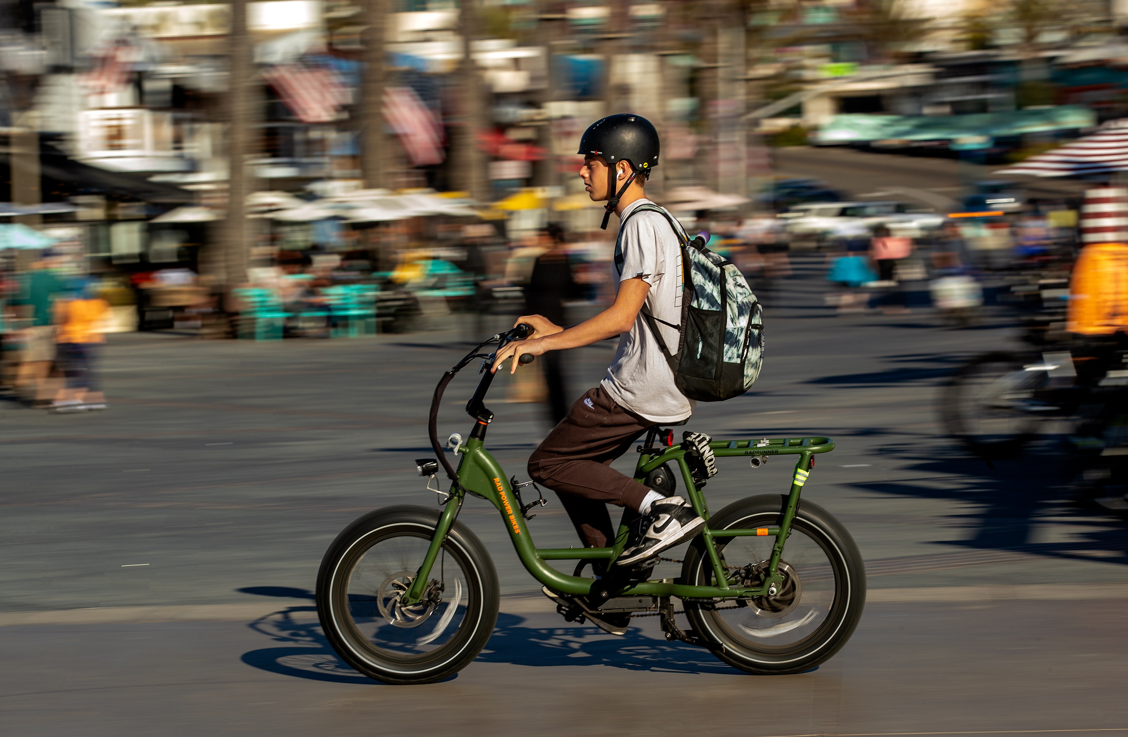 A person rides a green bike.