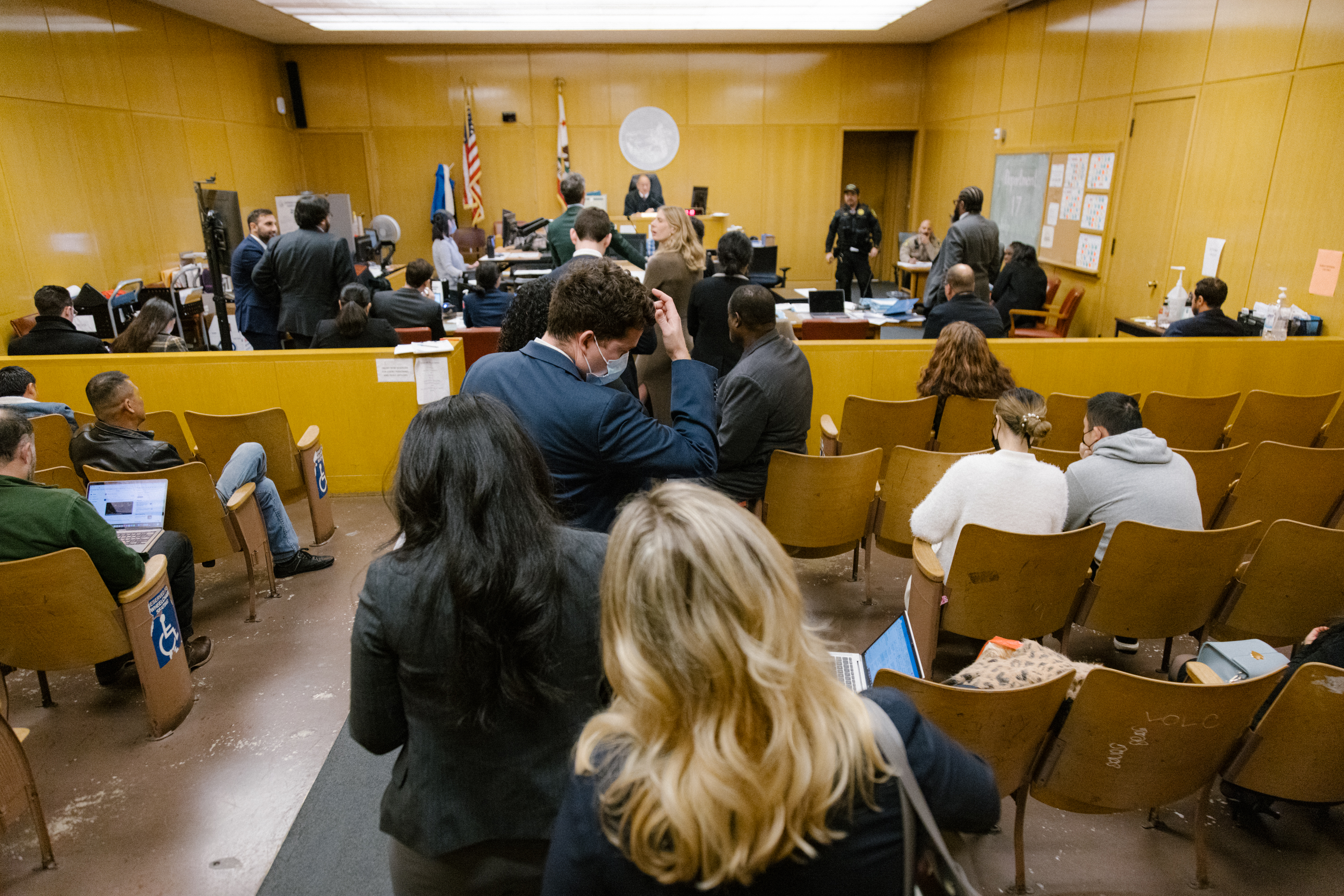 A line of lawyers wait to have their cases heard in court.