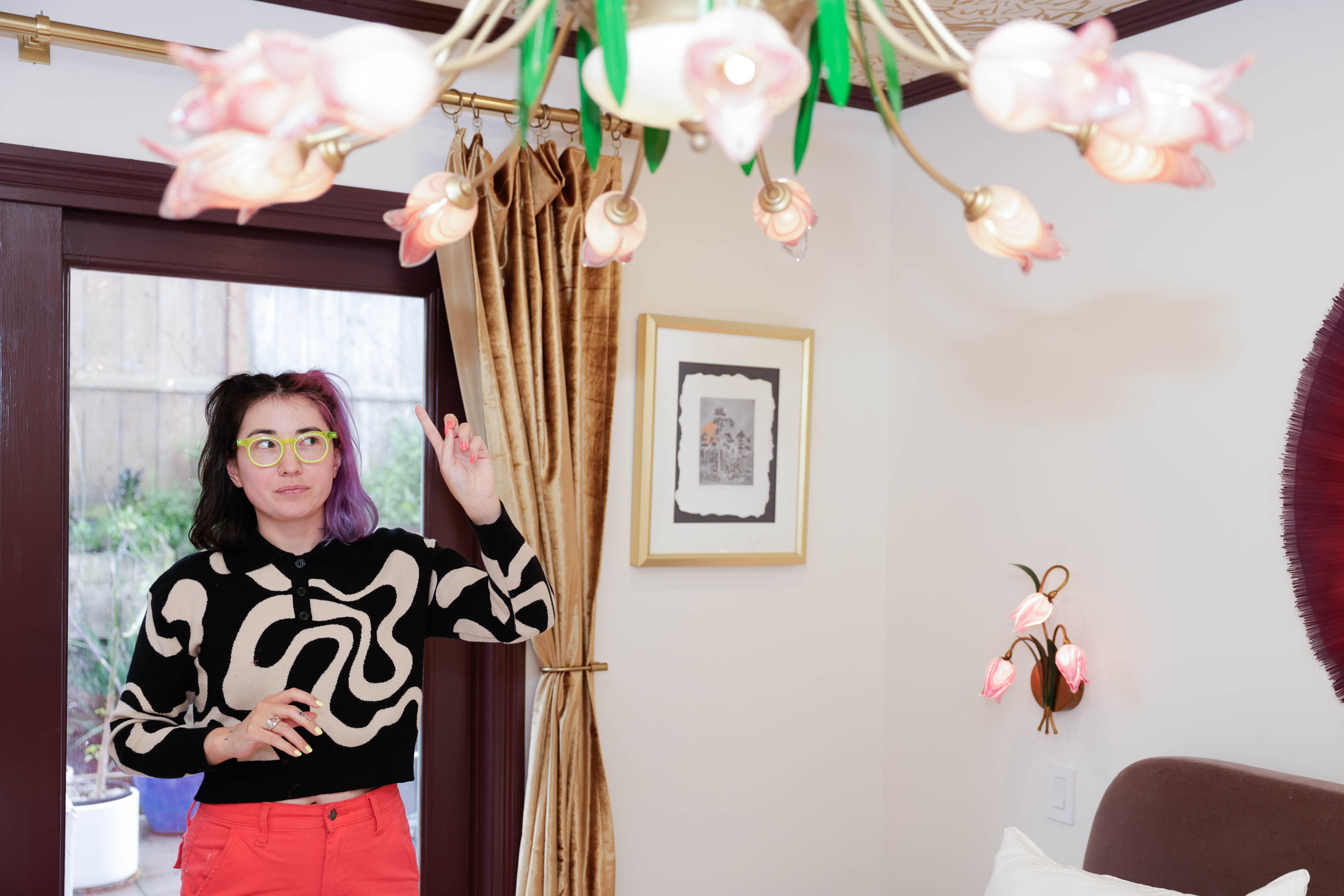 TikTok influencer Tay &quot;BeepBoop&quot; Nakamoto points to an elaborate tulip chandelier in a guest bedroom in the Instagram sensation, the Floral House. 