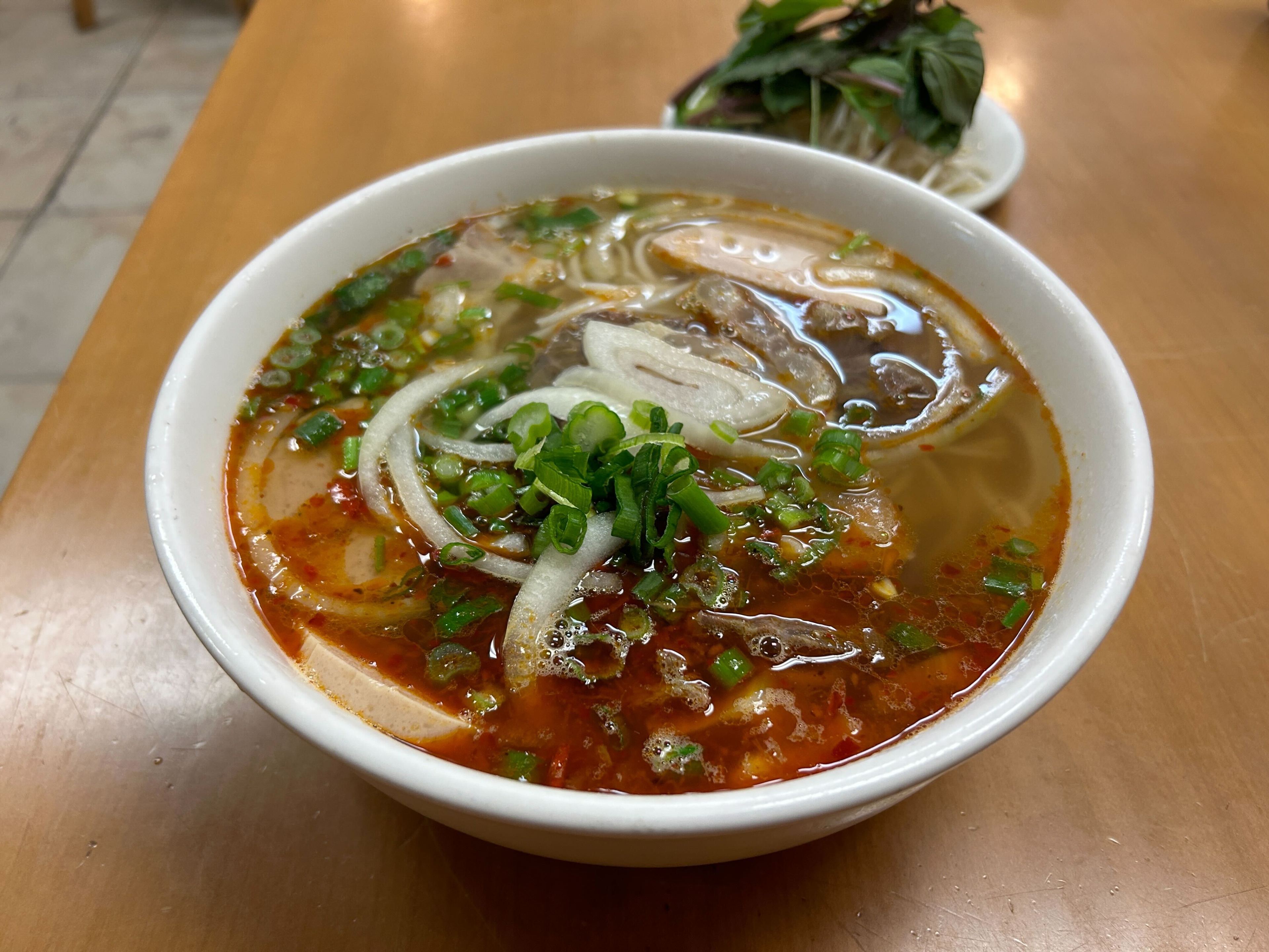 a bowl of beef pho with noodles