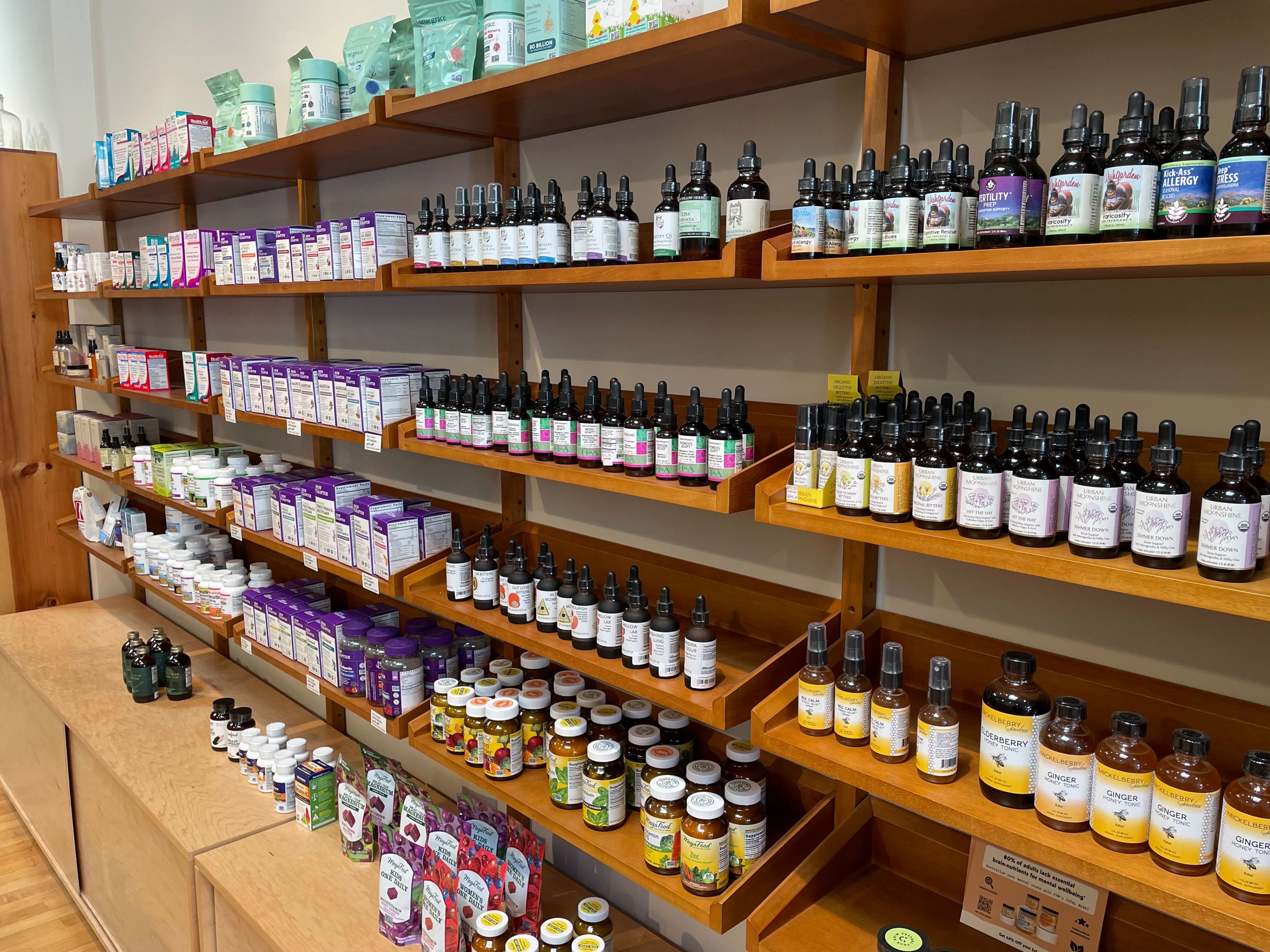 A shelf contains essential oils and vitamin supplements.