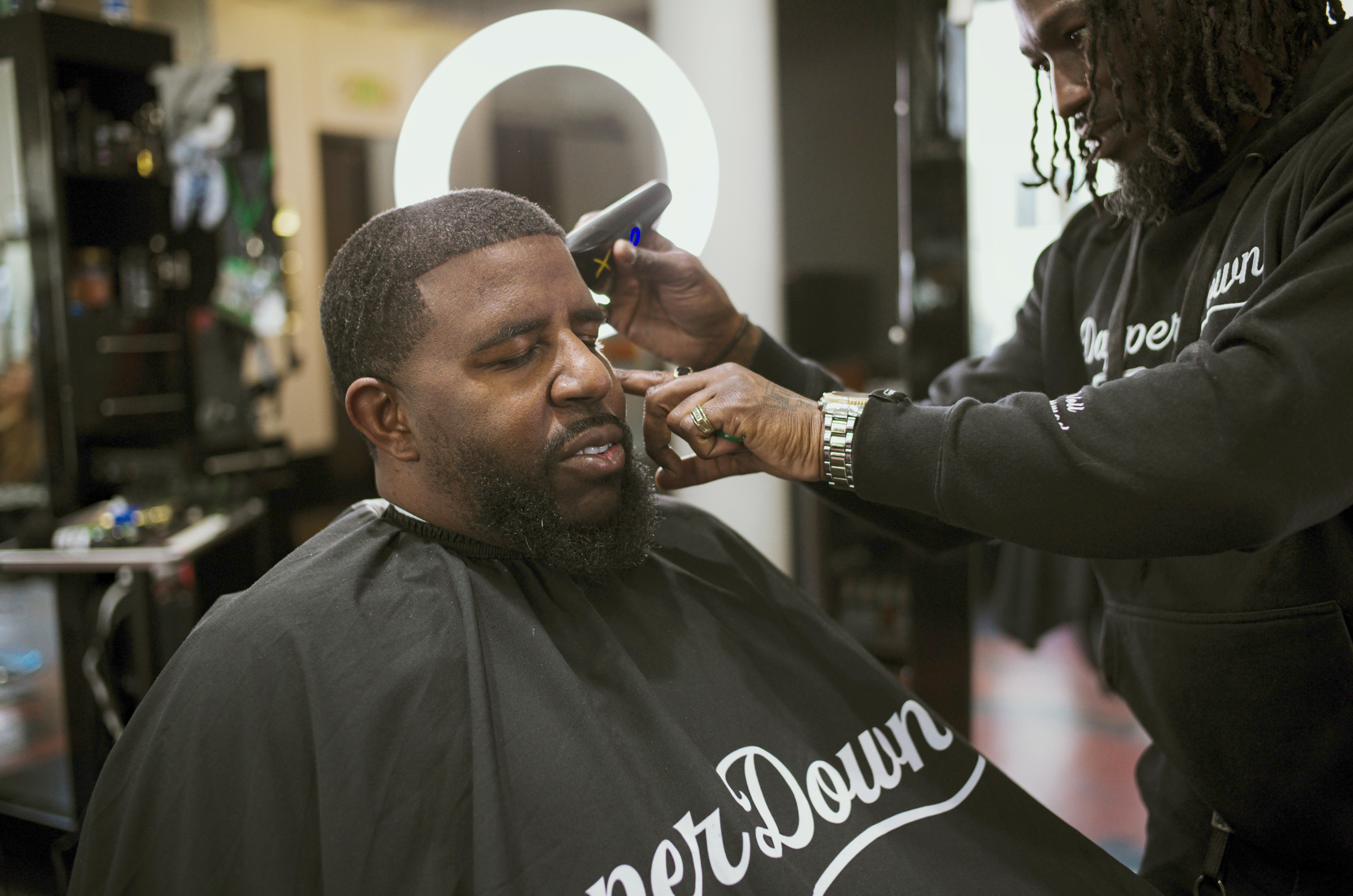 Adante Pointer, left, receives a haircut from Barber Bryce Ward inside Dapper Down Barber Lounge in San Francisco on Tuesday, Feb. 6th, 2024.