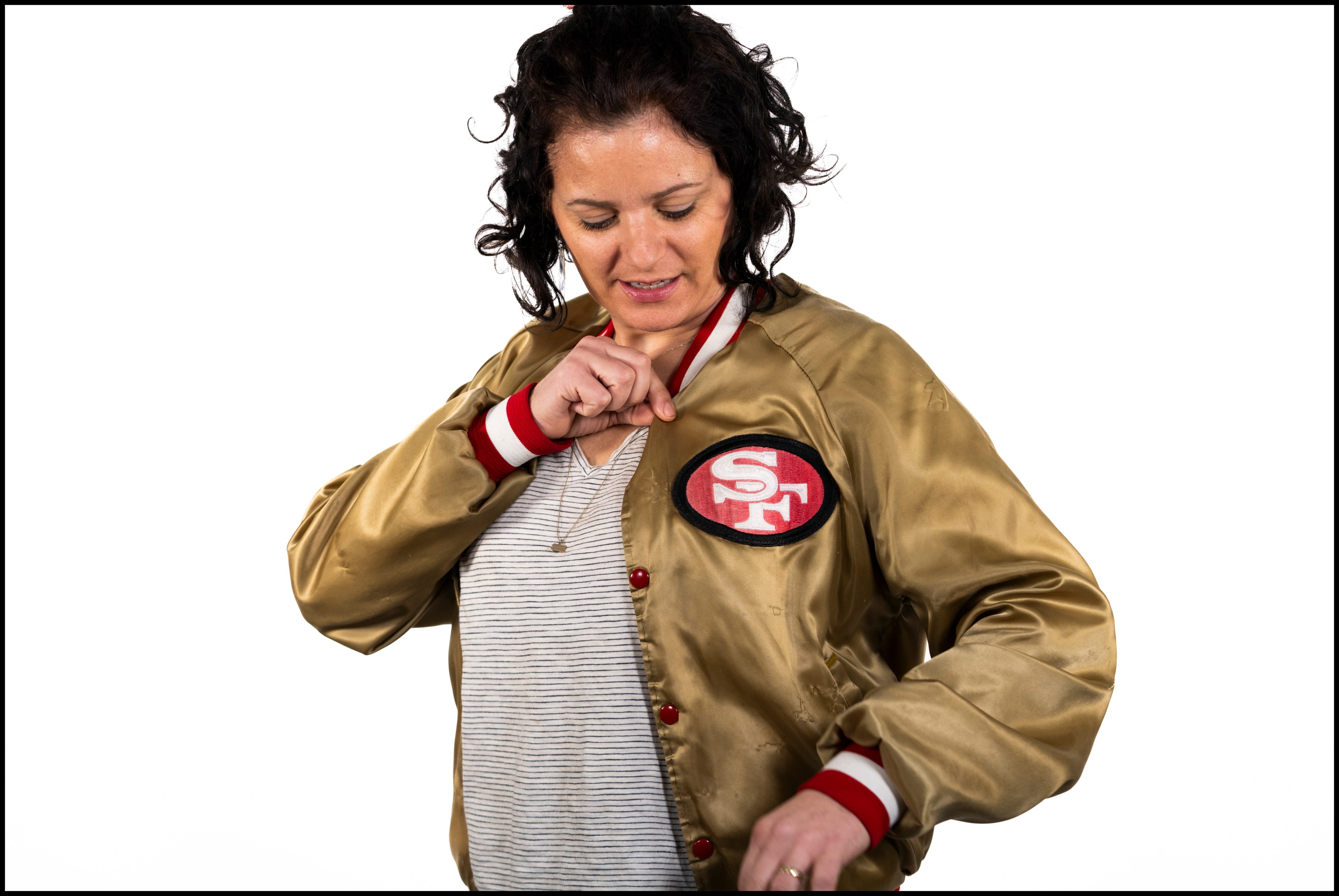 A person models a gold and red jacket. 