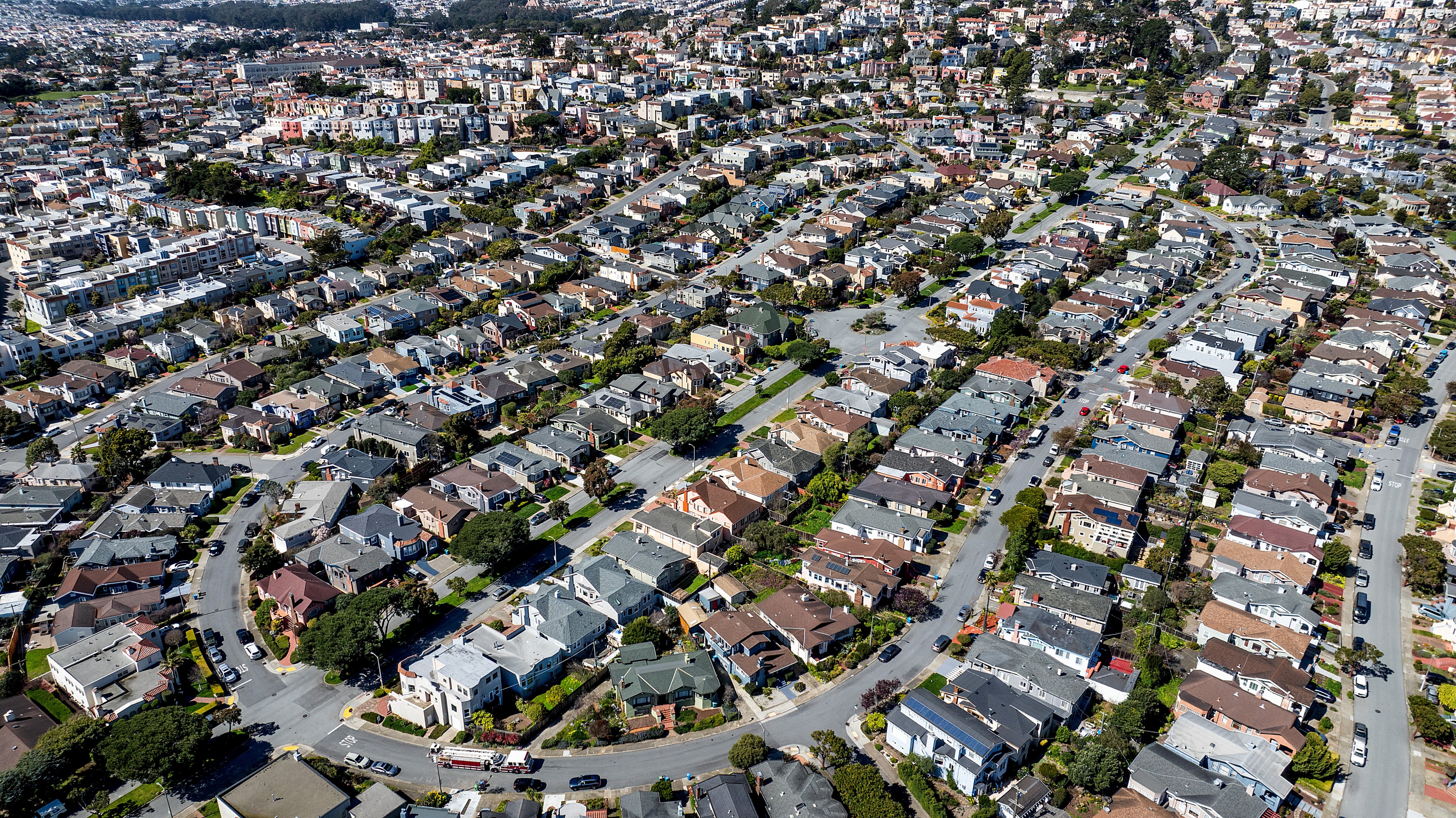 Aerial view of a dense residential area with rows of houses and intersecting streets.