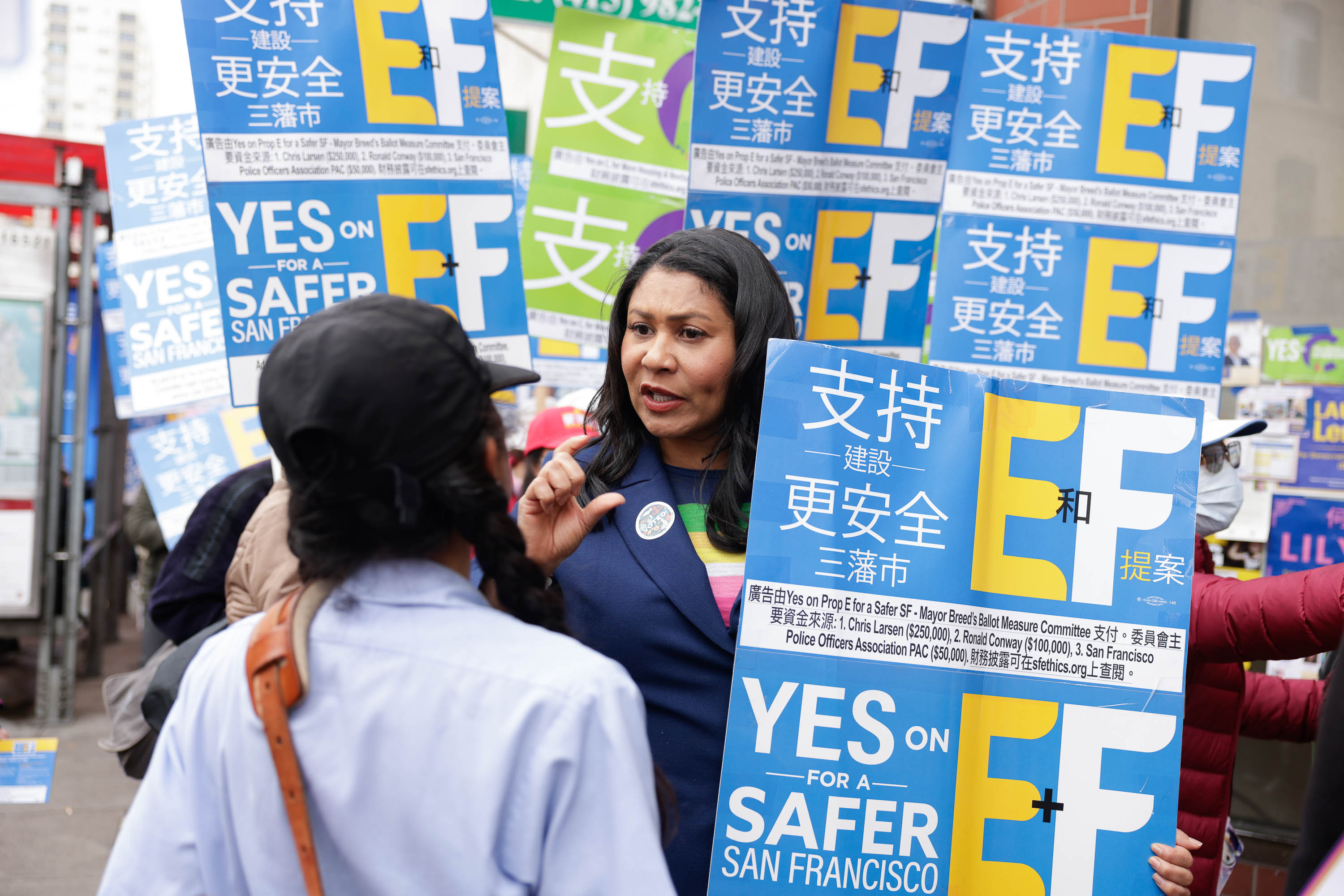 A person campaigning with &quot;Yes on EF&quot; signs for a safer San Francisco.