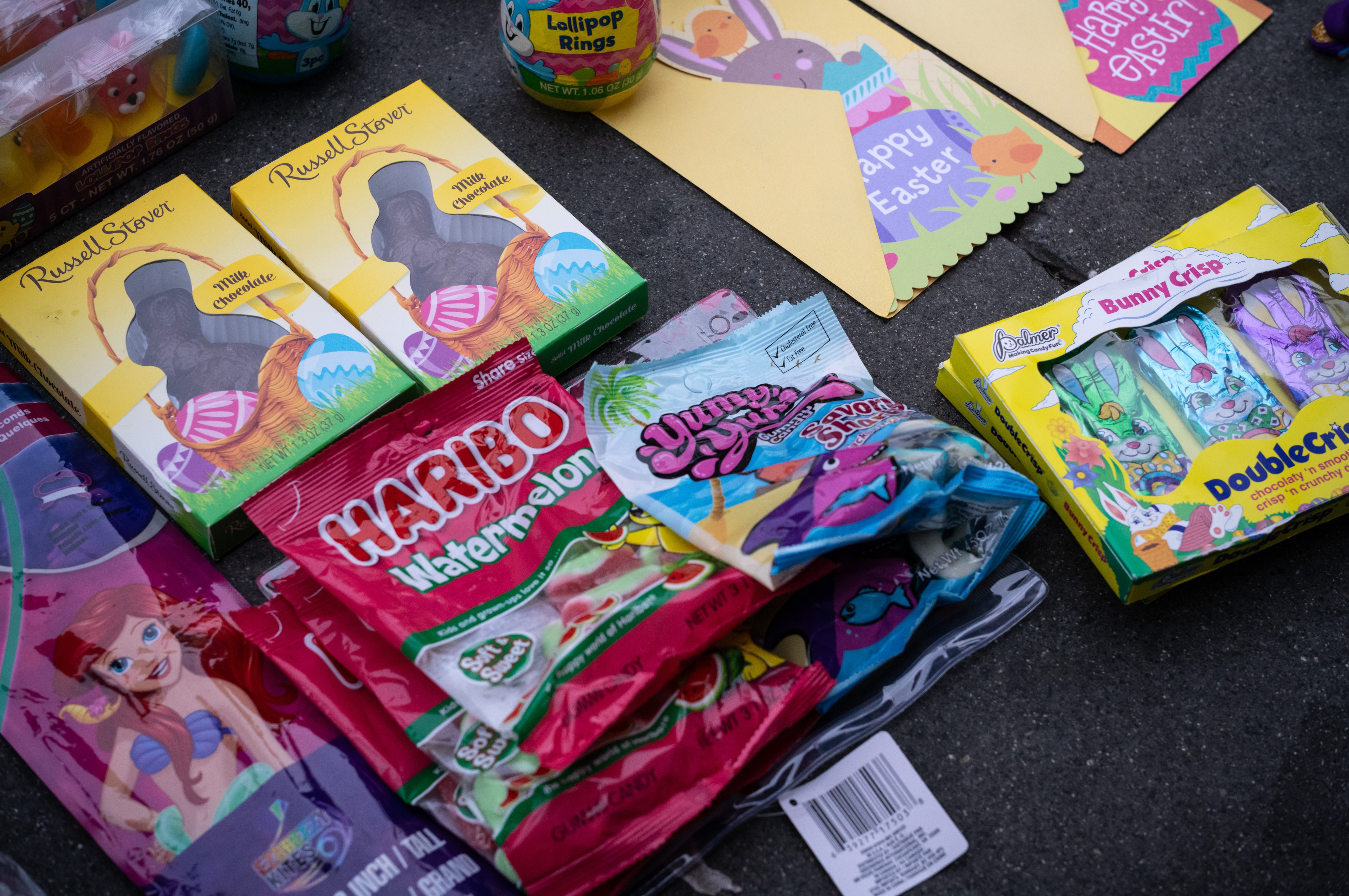 Assorted Easter candies, including Haribo and chocolate bunnies, displayed on the ground.