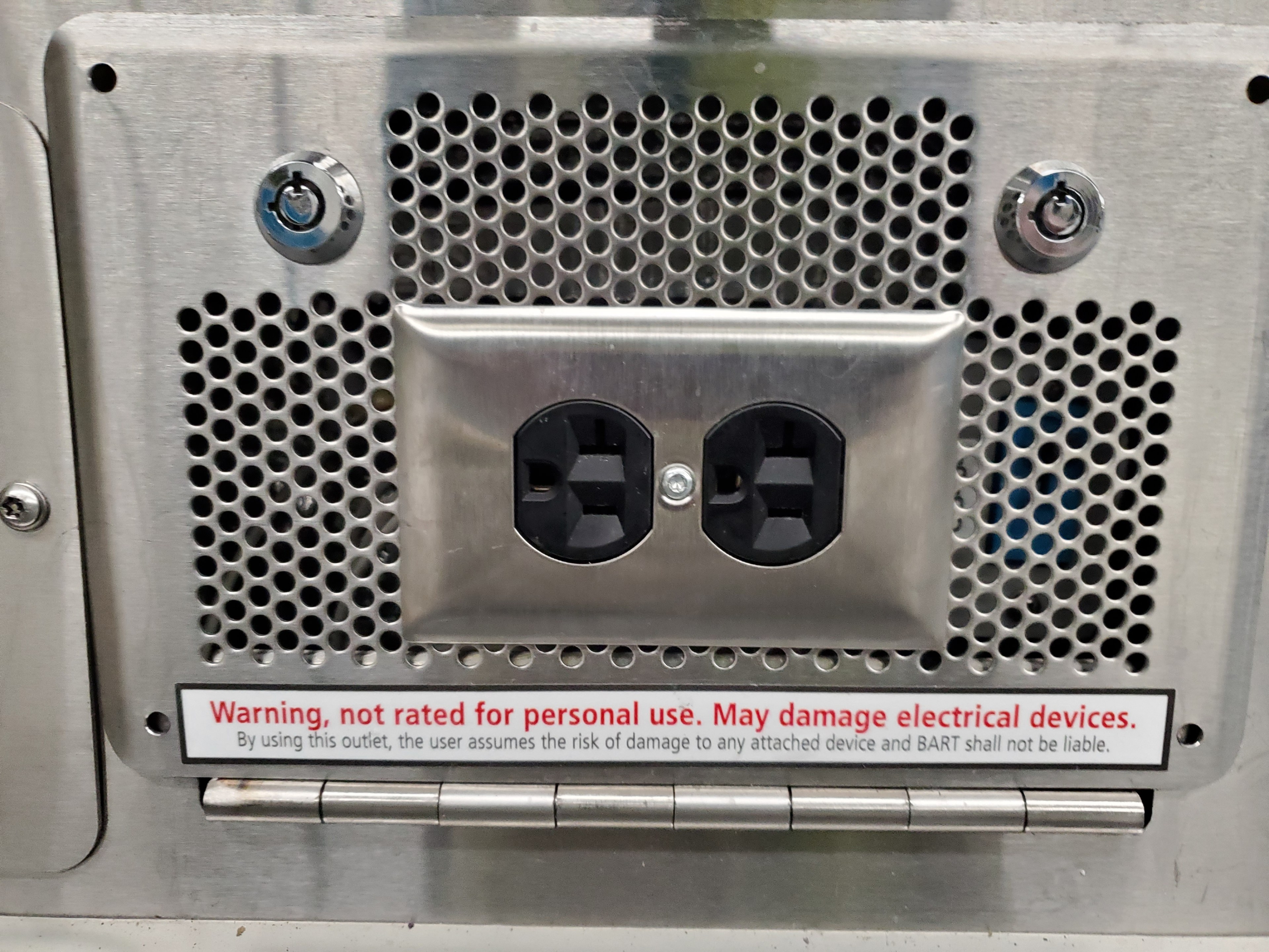 A sign on an electrical outlet warns users to tap into it at their own risk.