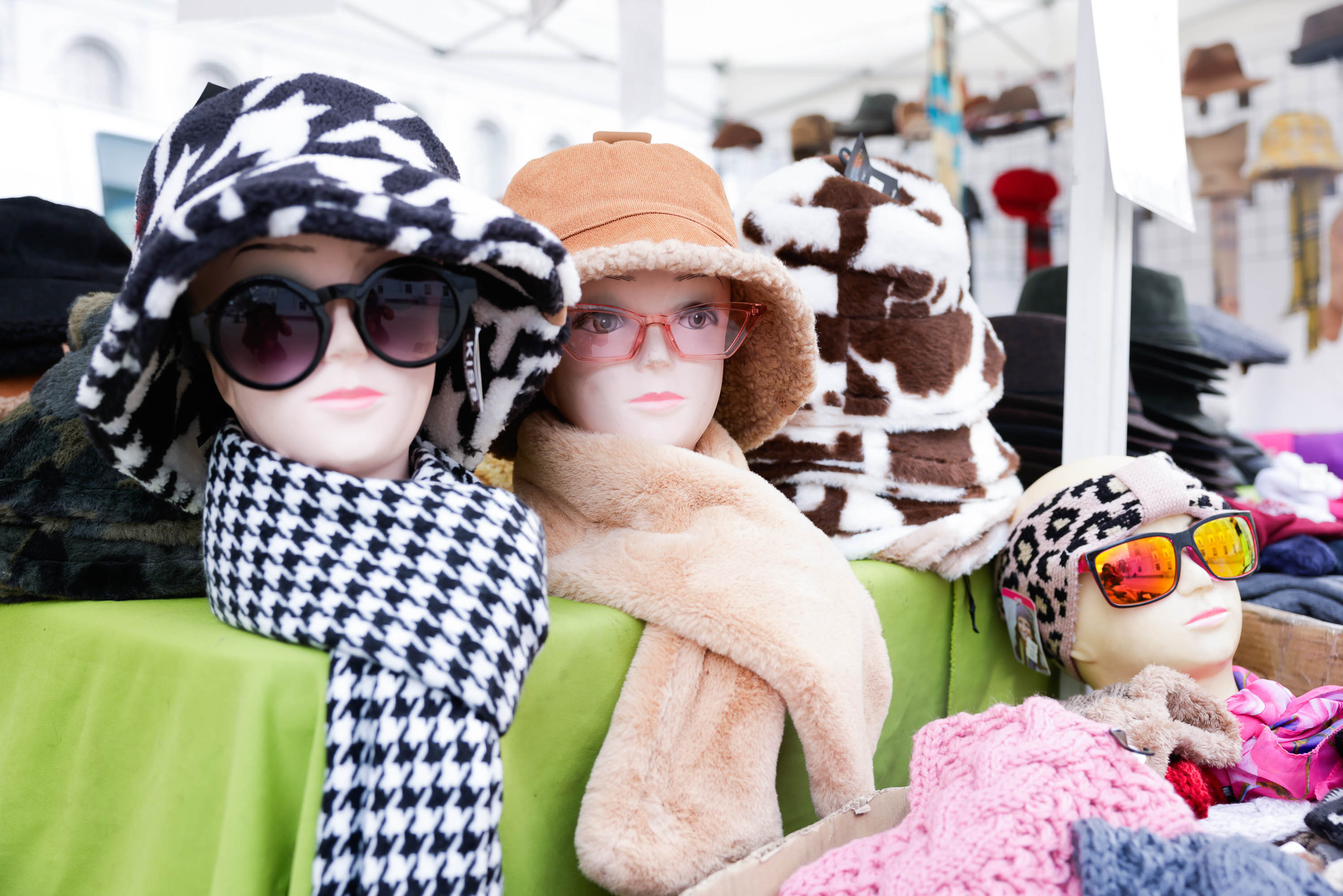 dummies sport womens hats, sunglasses and scarves on a merchandise table