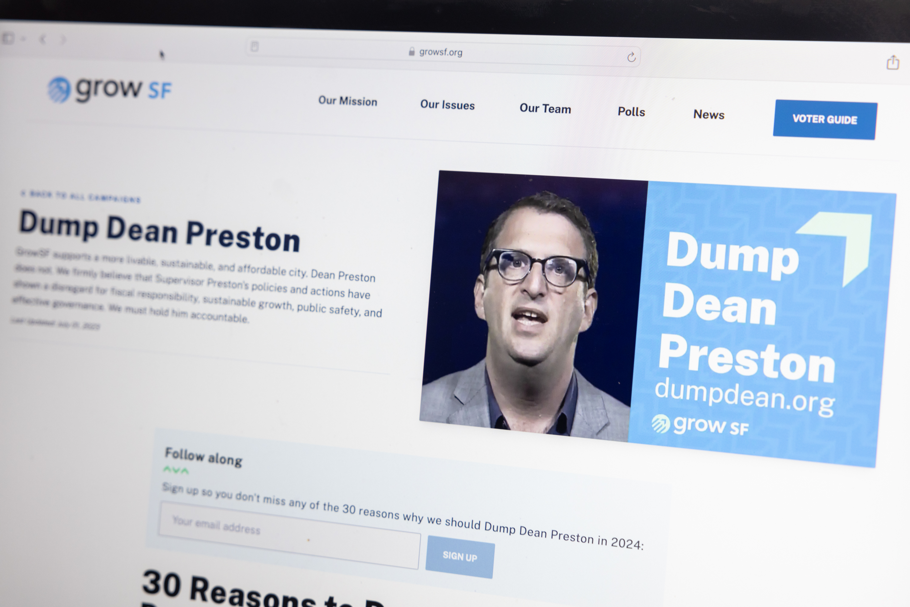 A computer screen displays a website with text &quot;Dump Dean Preston&quot; and a man's photo.