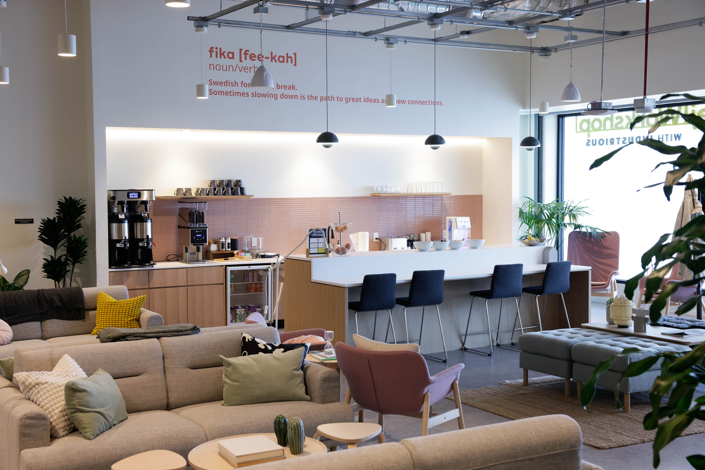 A cozy lounge with sofas, chairs, and a coffee station, designed for breaks and socializing.