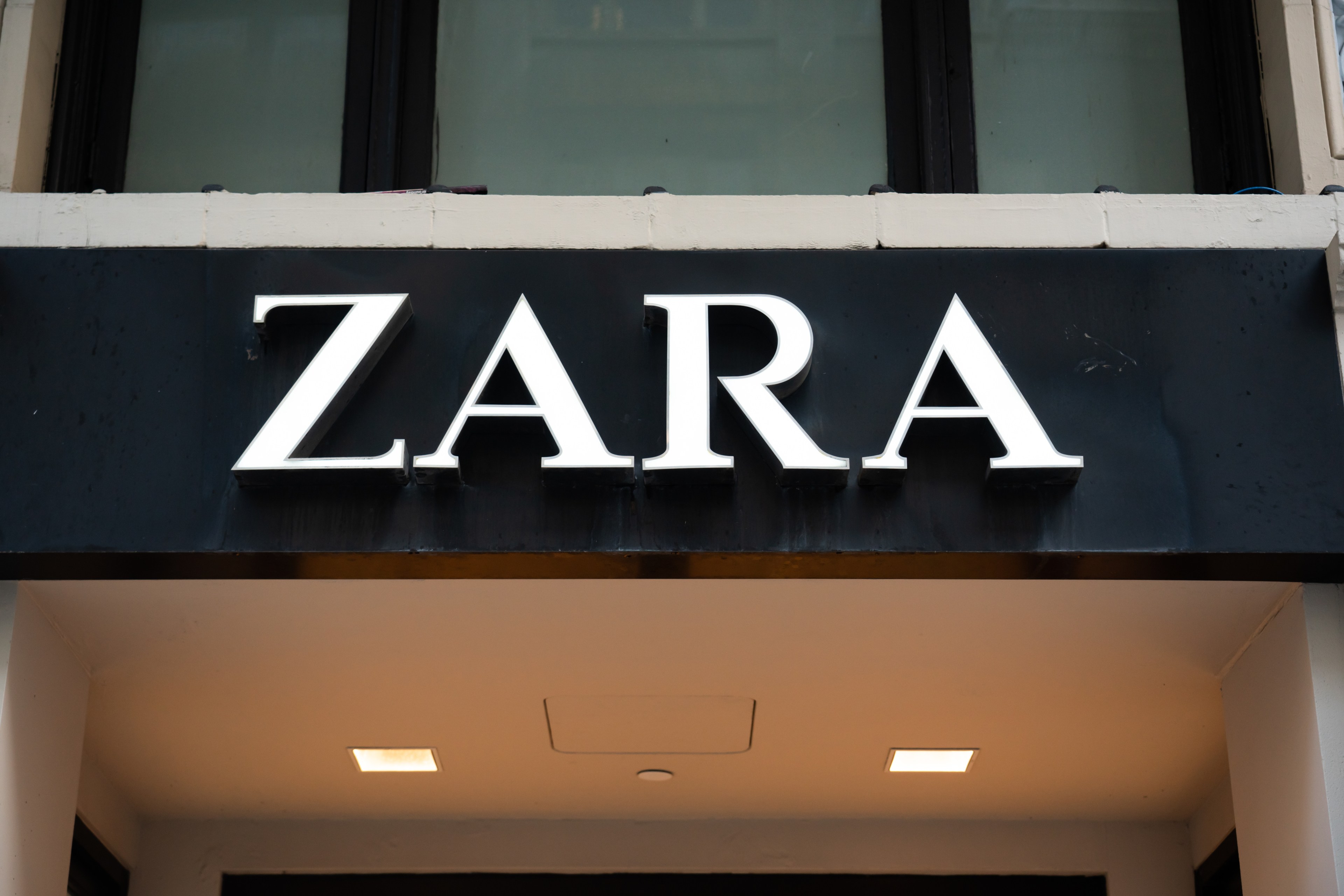 A ZARA store sign above a shop entrance with large white letters against a black background.