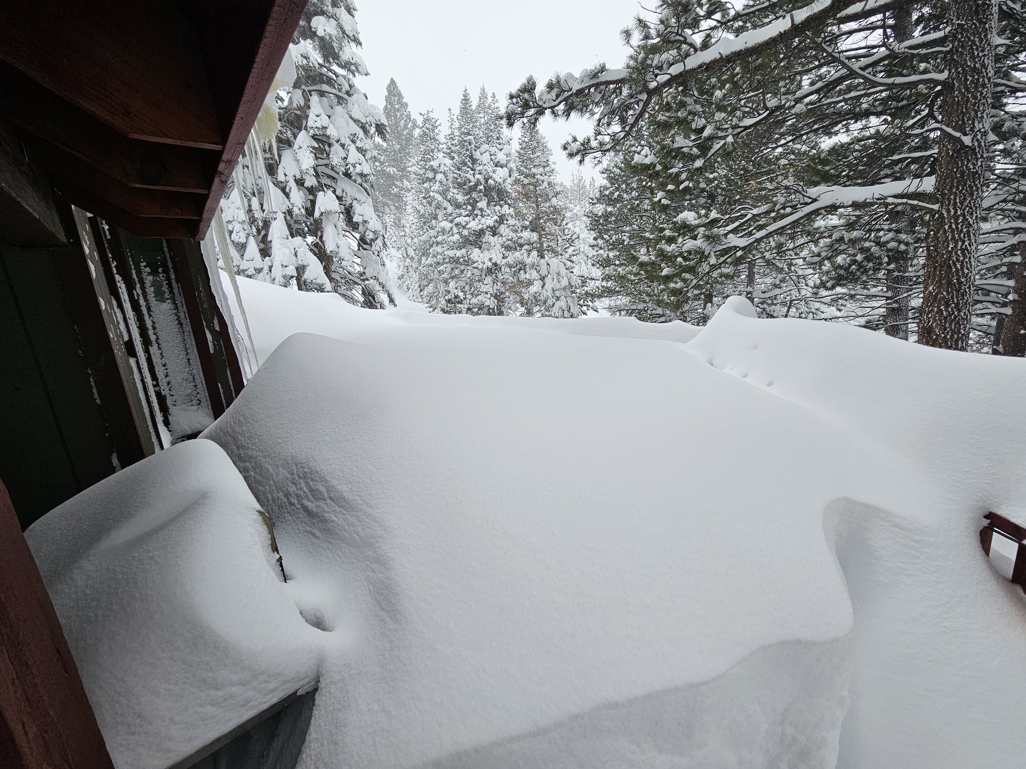 A heavy snow pack seen outside a home