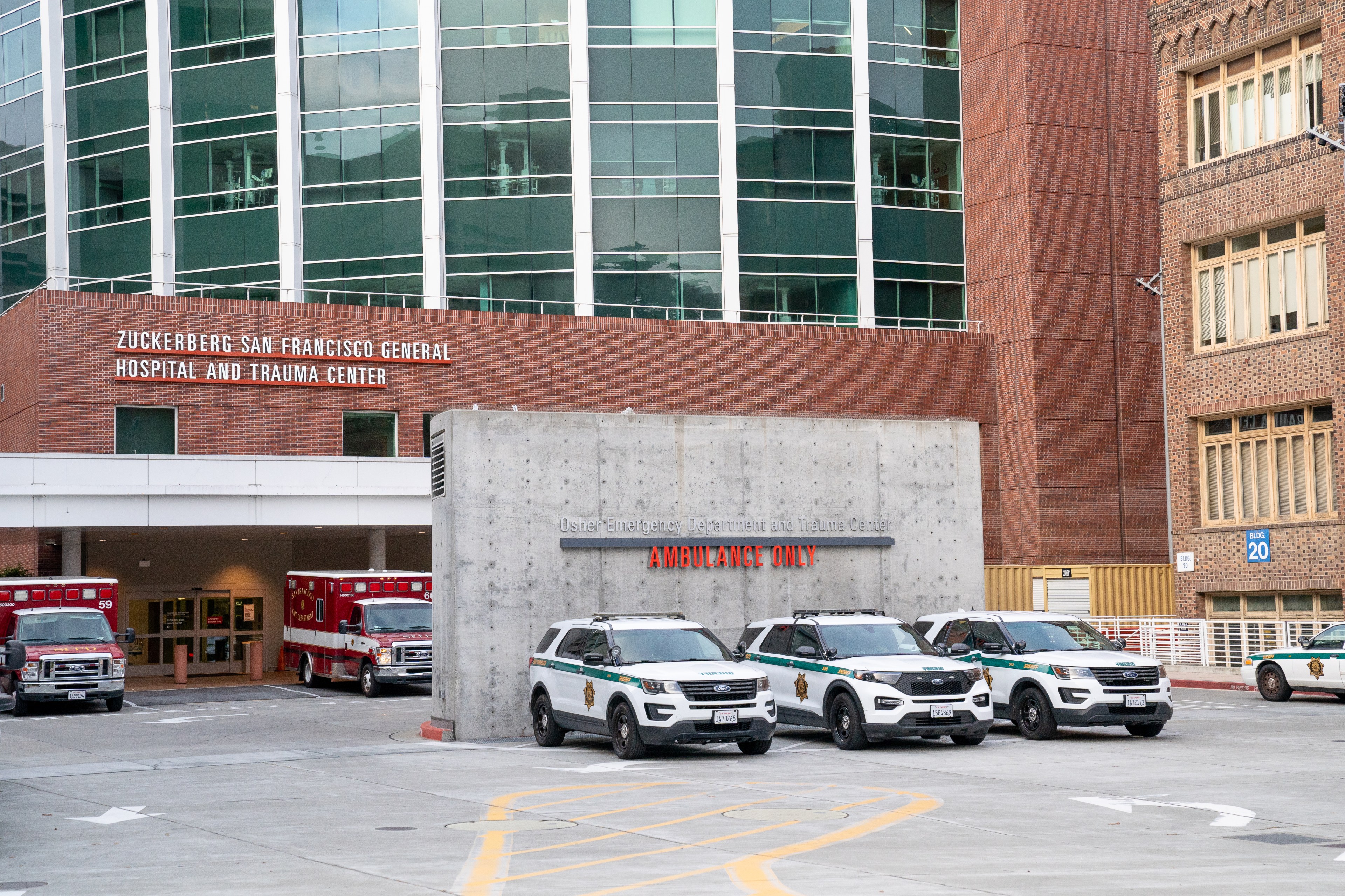 Sheriff's deputies patrol vehicles sit parked outside a hospital.