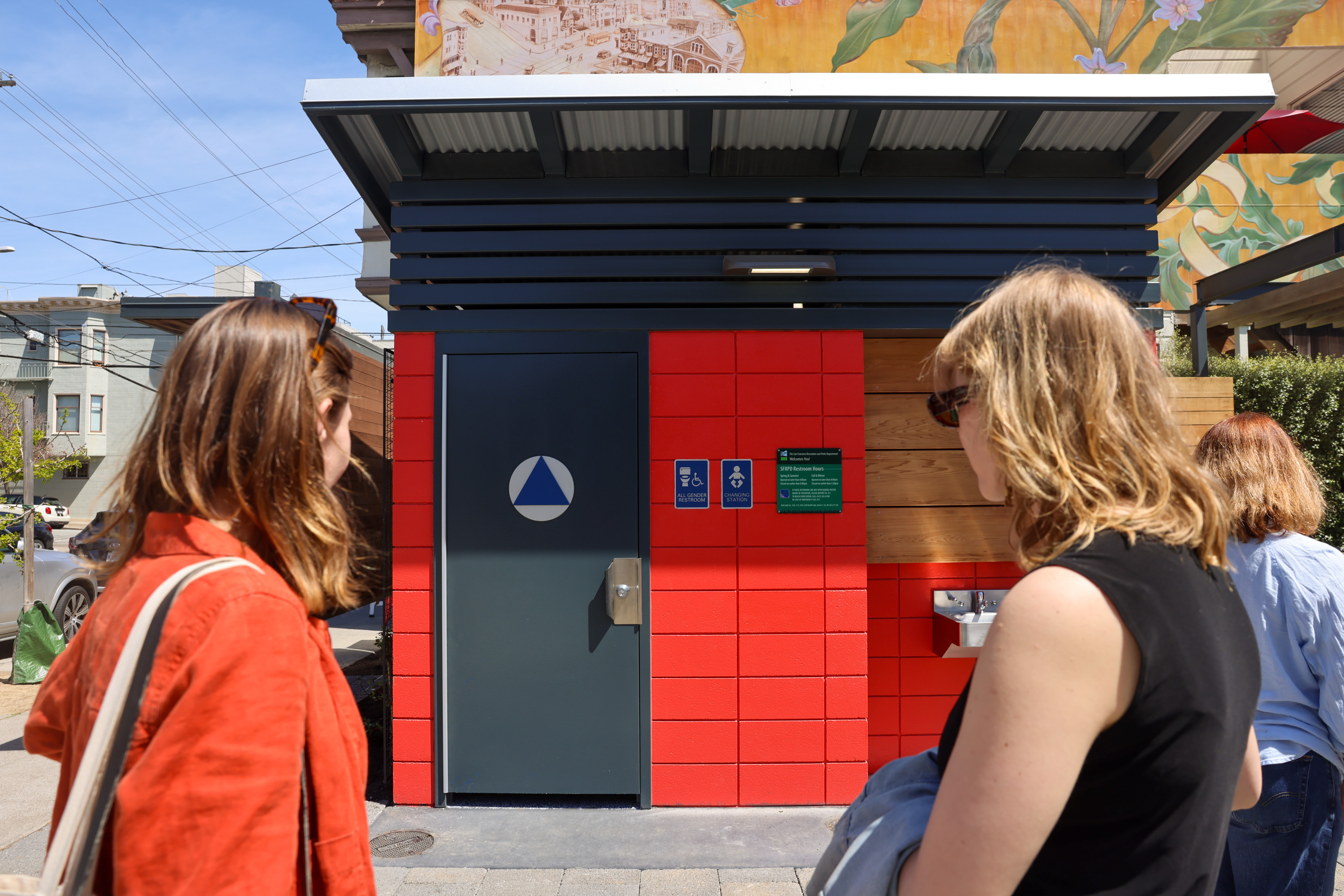 Adrienne Meyers, left, and Grace Shaver check out the new public restroom in the Noe Valley Town Square in San Francisco on Tuesday.