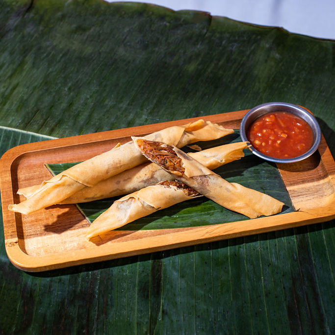 sweet potato lumpia served on a plate with ketchup