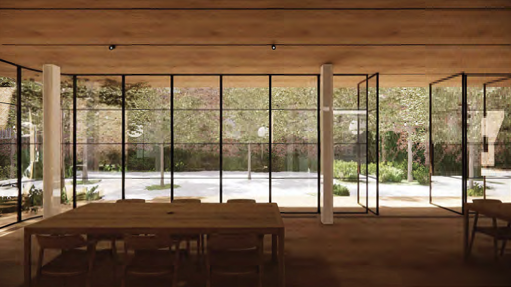 Inside a modern room with large glass windows overlooking a courtyard with trees and a paved area.