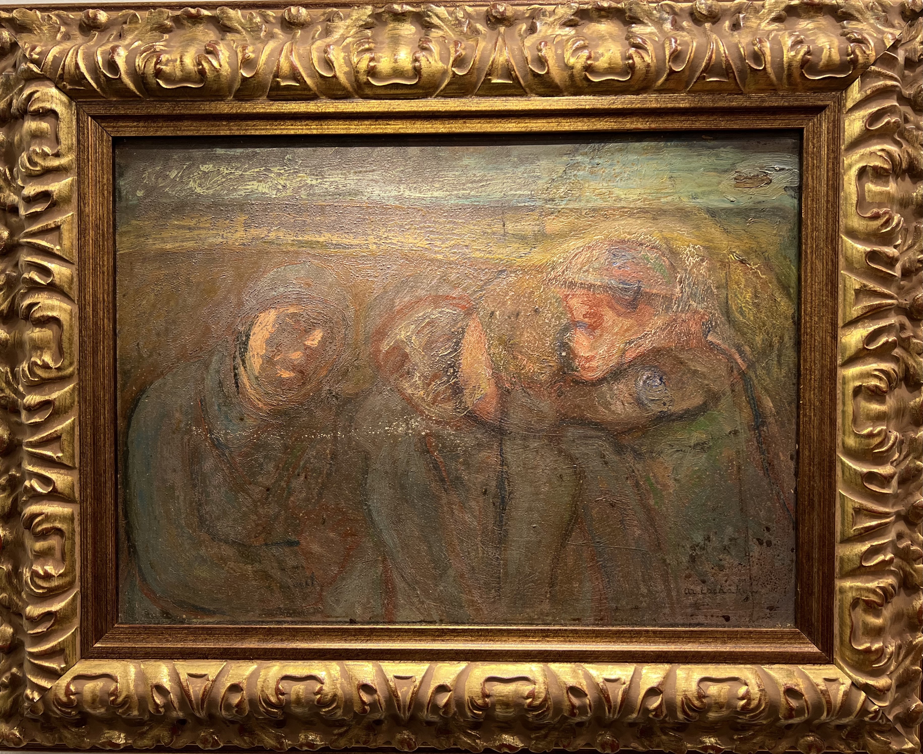 Ornate gold frame containing an impressionist painting showing blurred figures possibly in an embrace.