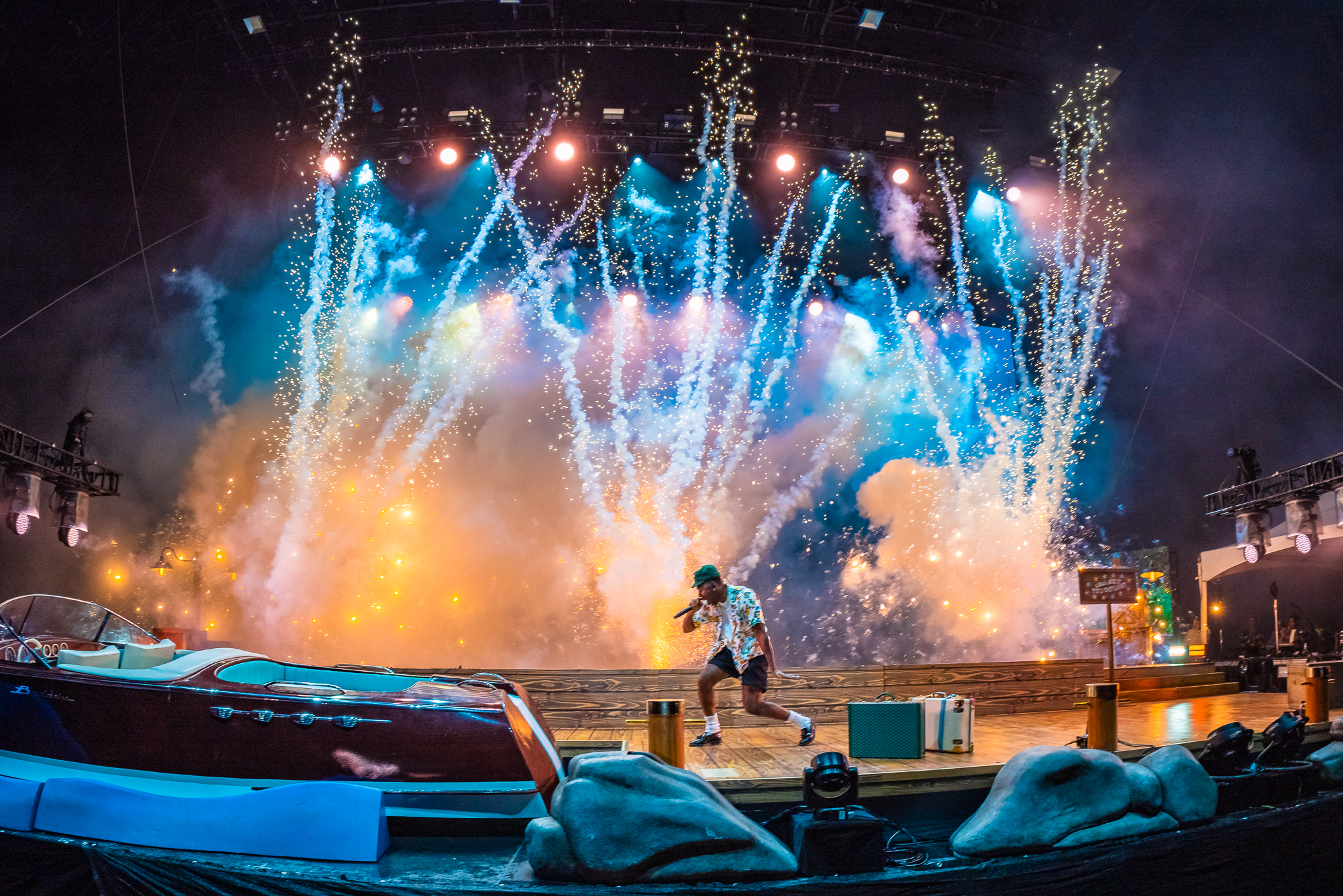 pyrotechnics above a festival stage with a rapper performing