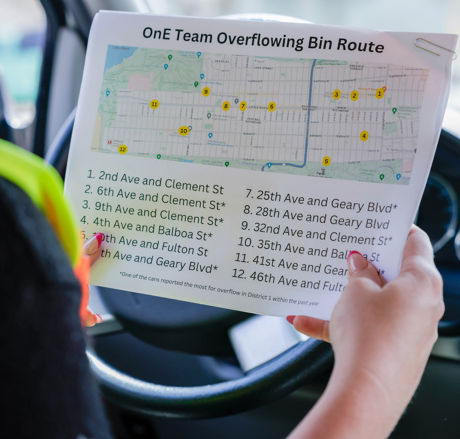 A person holds a paper with a map titled &quot;Overflowing Bin Route,&quot; listing 12 locations with corresponding map points.