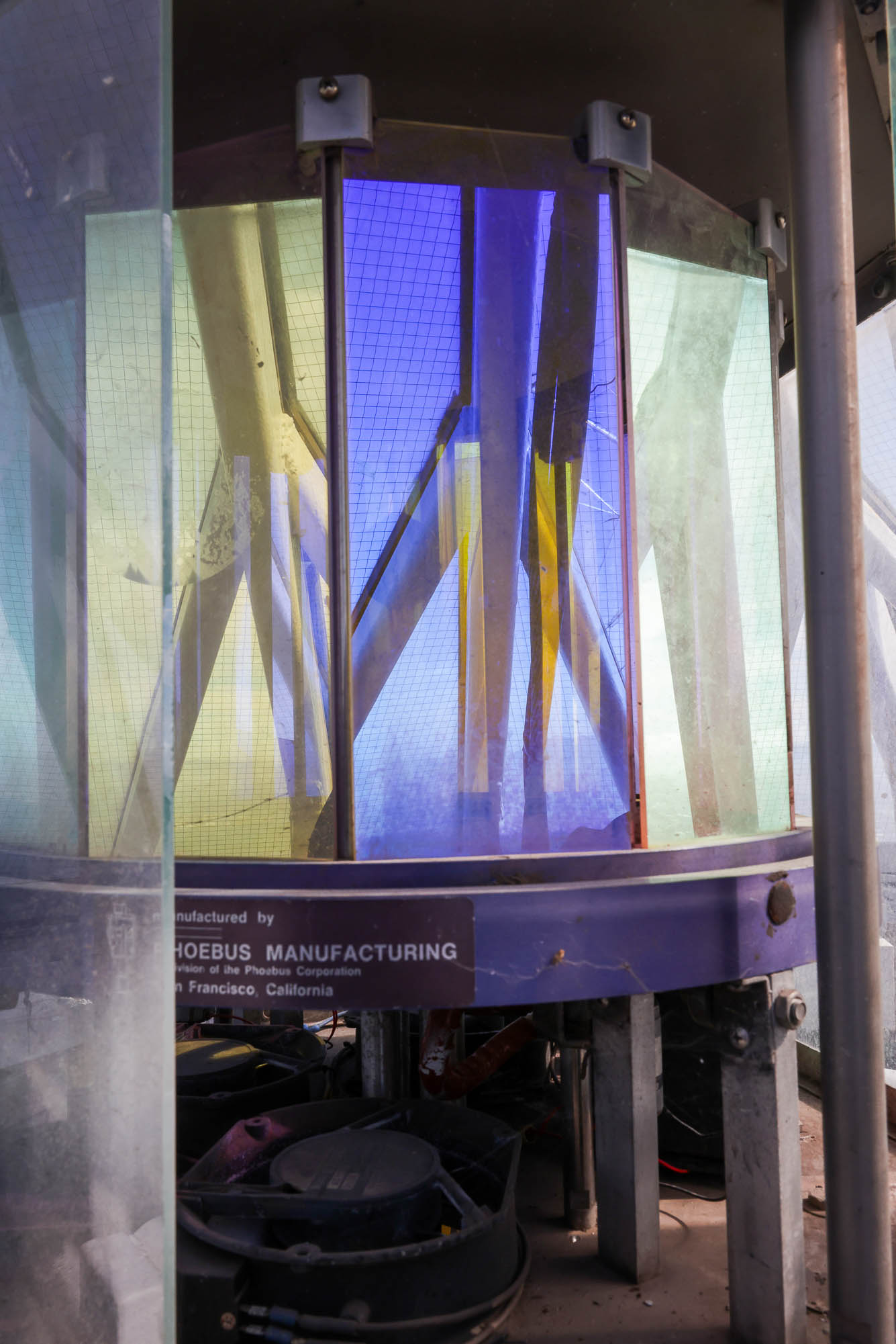 Colorful vertical glass panes within a metal enclosure, with a label &quot;PHOEBUS MANUFACTURING.&quot;