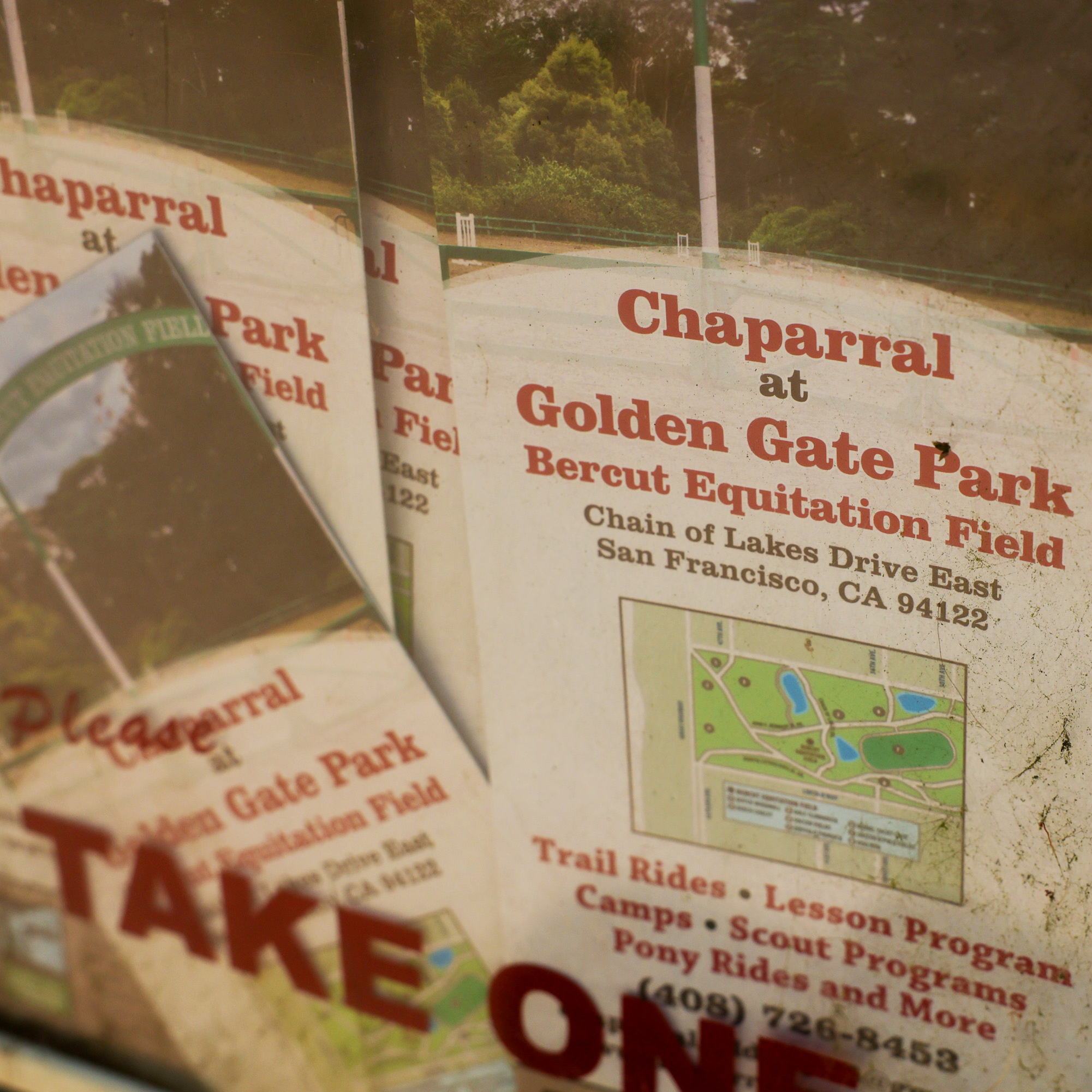 The image shows a worn poster with a map and text advertising &quot;Chaparral at Golden Gate Park&quot; in San Francisco, featuring trail rides and camps.