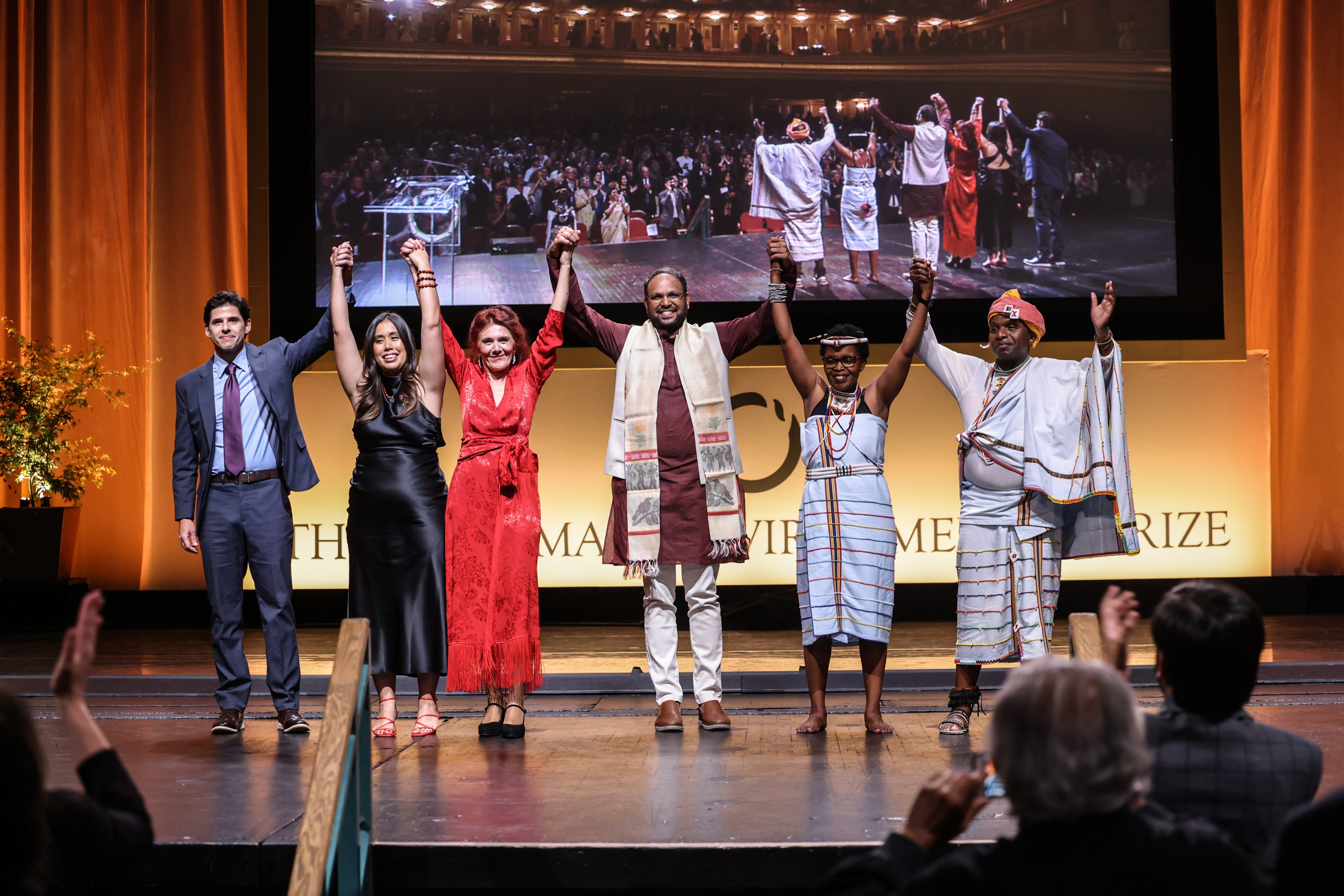 Winners of the 35th annual Goldman Environmental Prize celebrate as a group on stage at the ceremony.