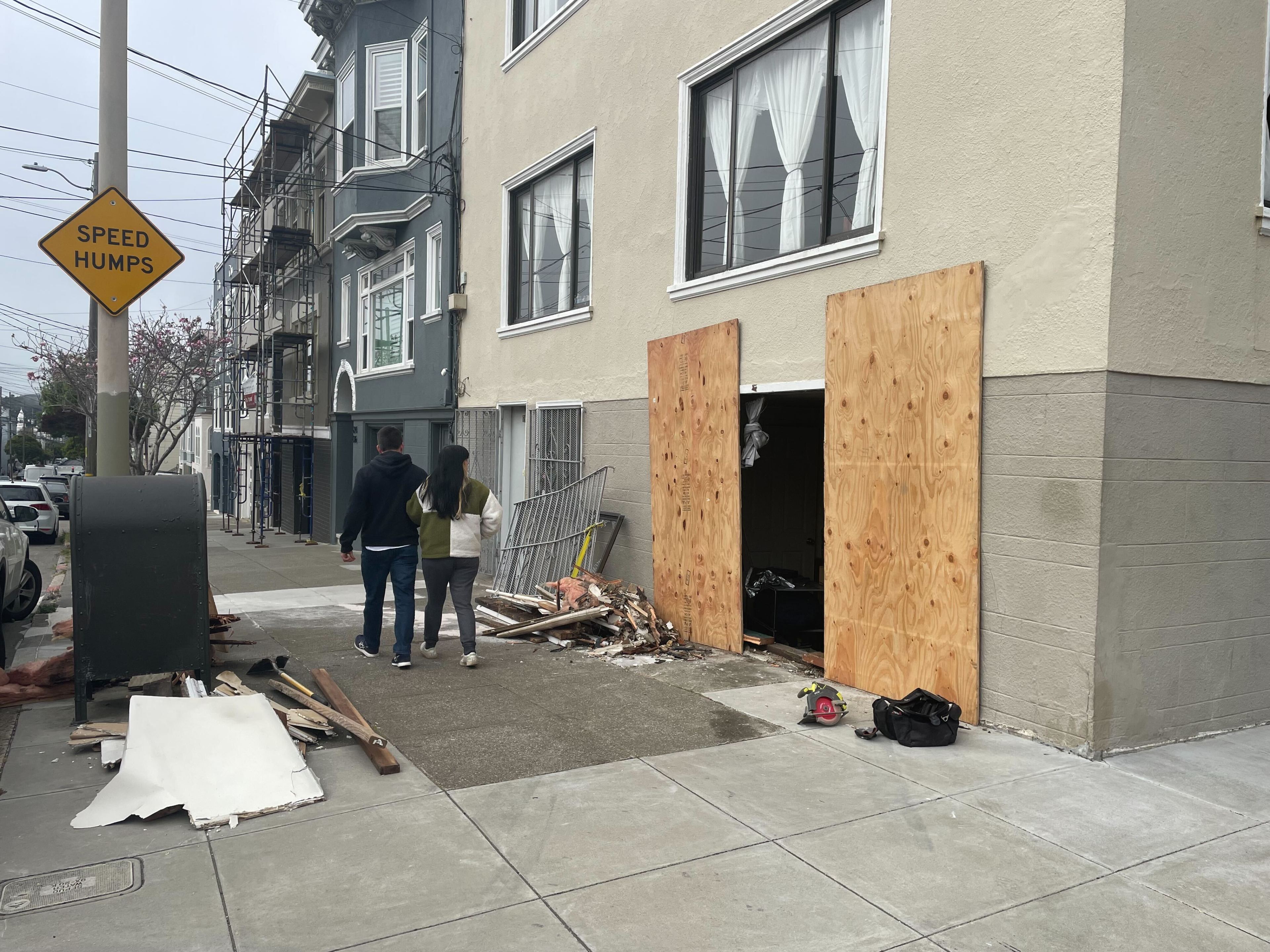 Wreckage from a crash at an apartment building at 698 Cabrillo St. is seen Tuesday after two men crashed a car into it hours earlier. The men were fleeing in the vehicle after robbing a woman at 26th Avenue and Balboa Street around 10:30 a.m. Tuesday, police said.