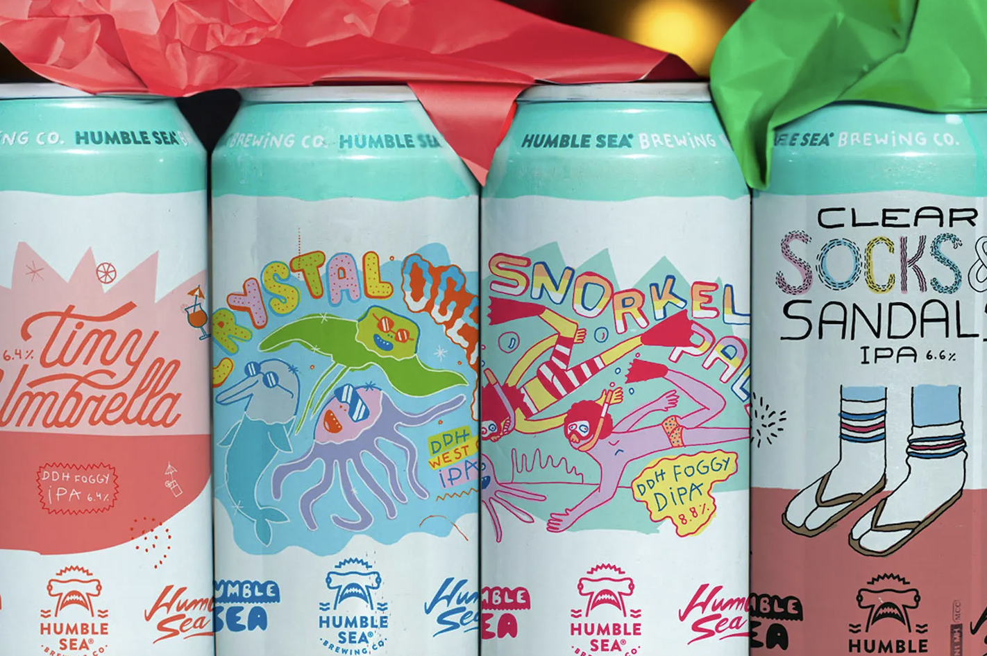 four tall boys of beer with festive packaging