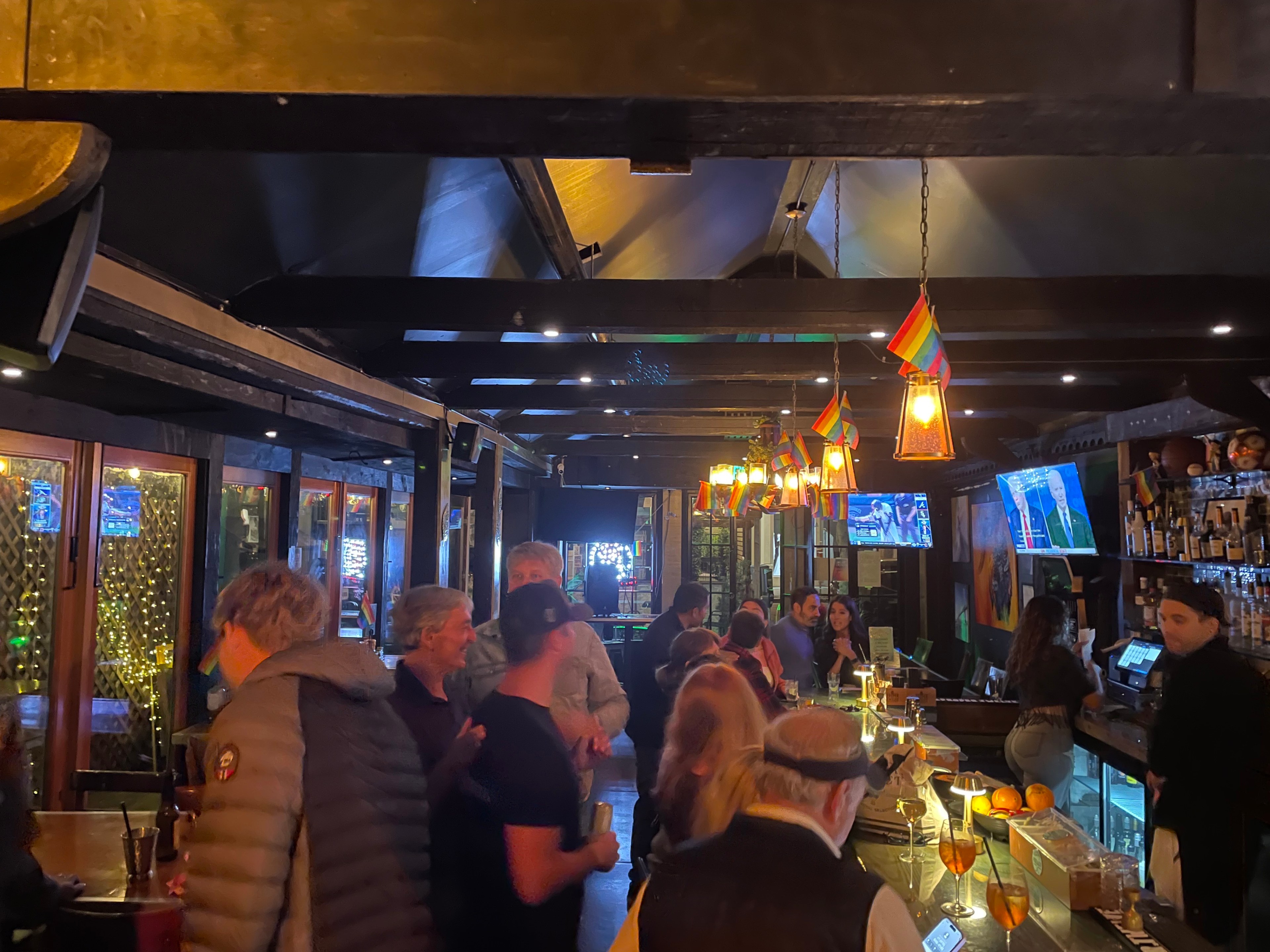 People mingle inside a bar.