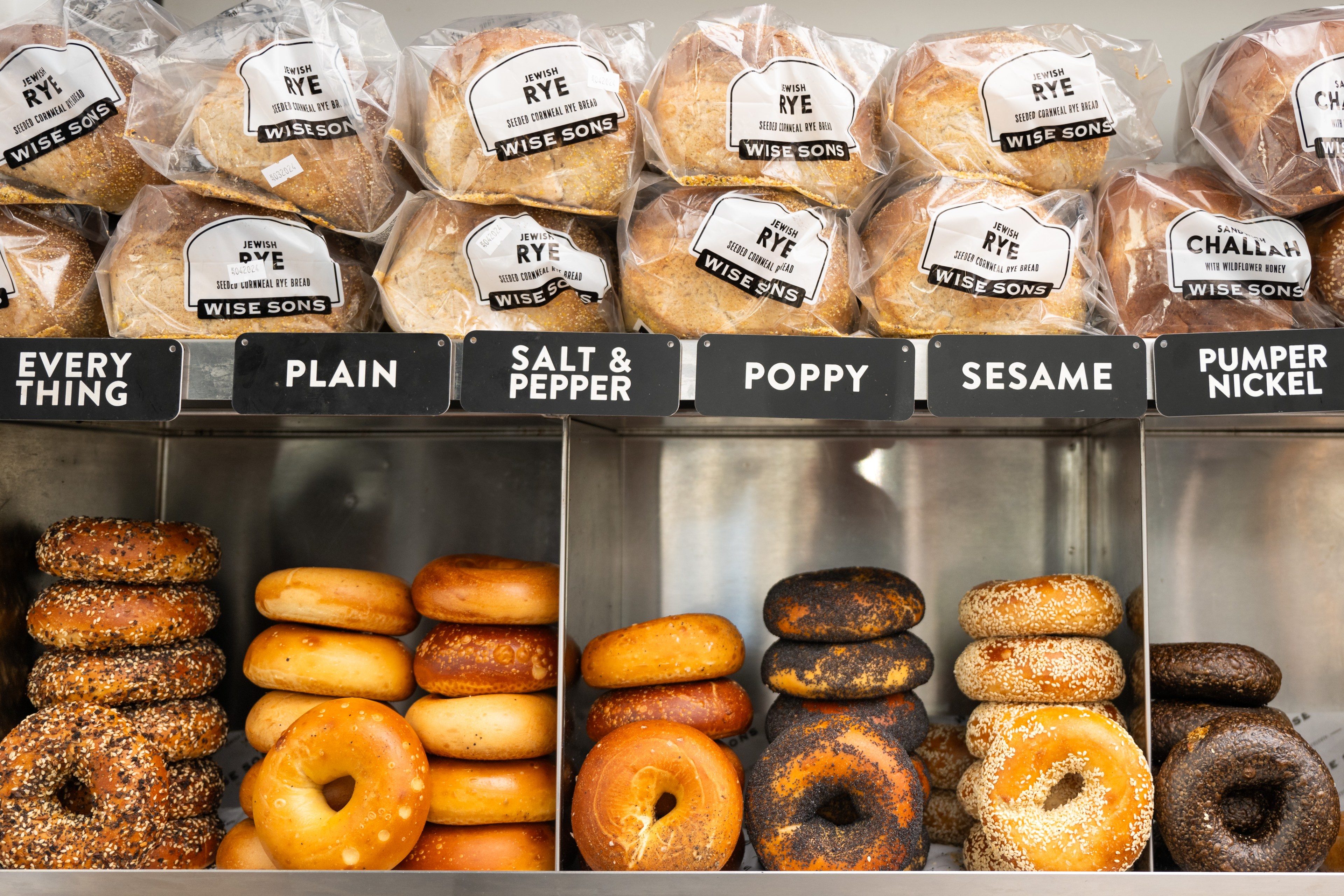 A selection of bagels at Wise Sons including loose bagels and bagged bagels.