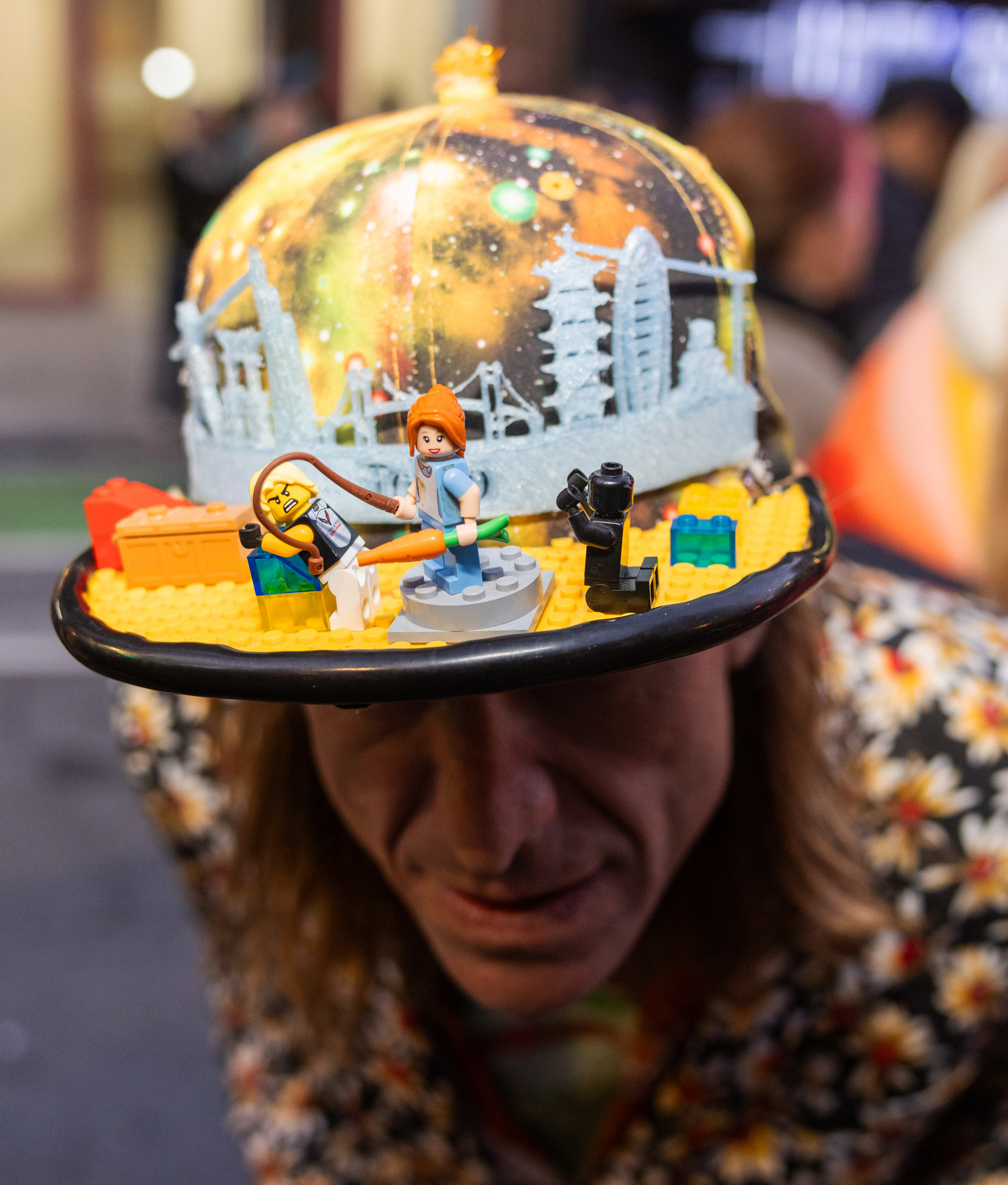 A man shows off his custom hat with legos on it.