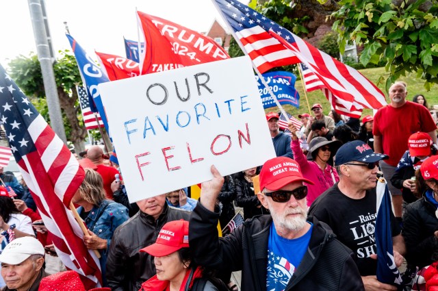 A crowd of people, many wearing red 