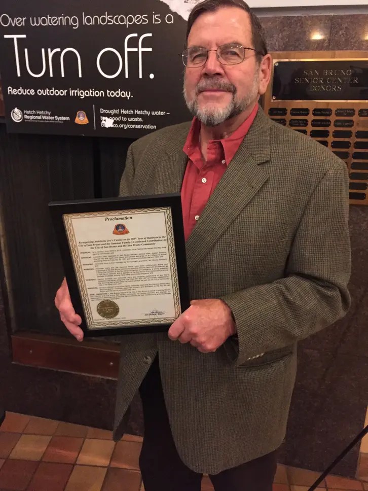 Dennis Sammut holds a certificate