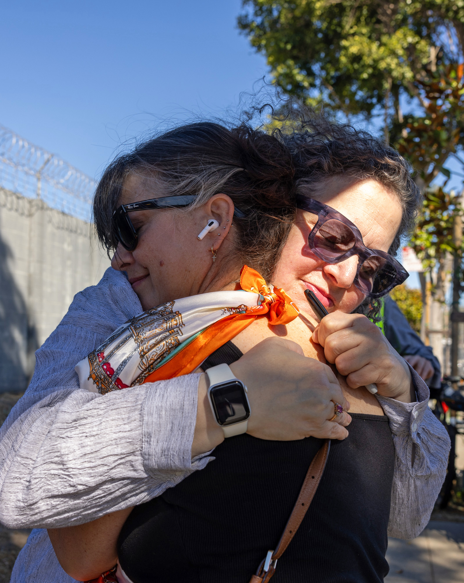 Two people hug each other.