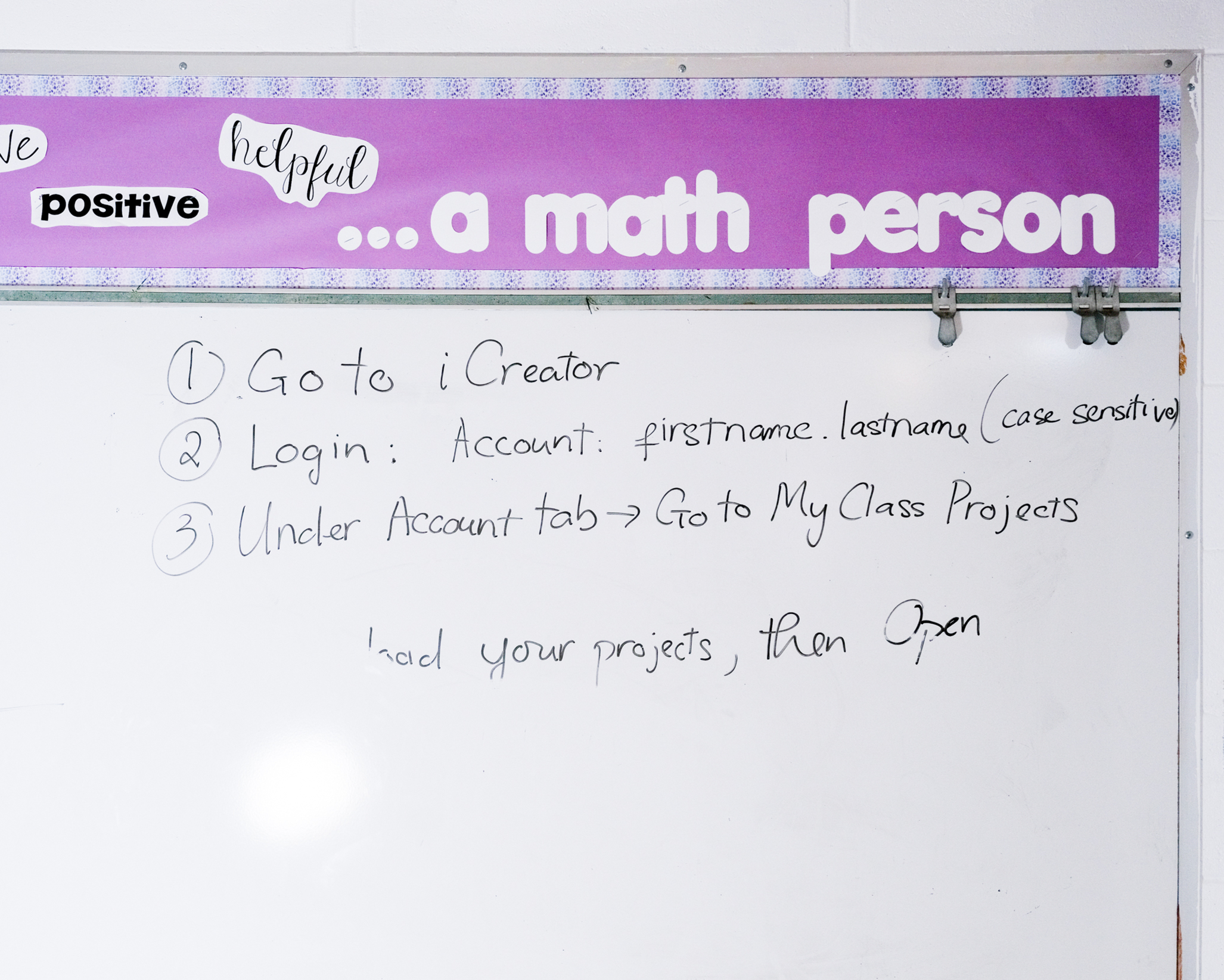 The image shows a whiteboard with three steps written for logging into iCreator. Above it, a purple border displays the words &quot;helpful&quot;, &quot;positive&quot;, and &quot;...a math person.&quot;