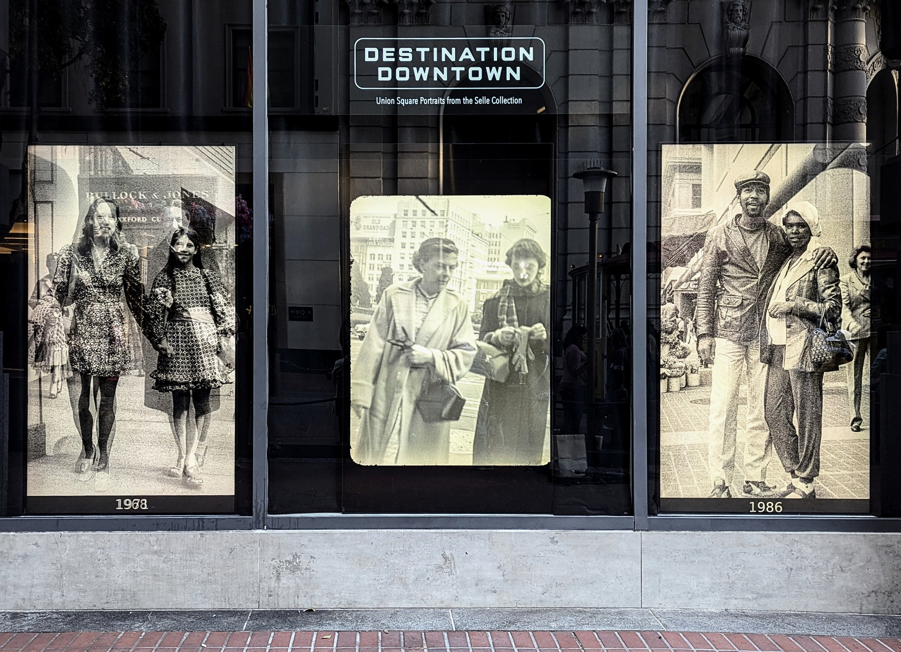 The image shows three black-and-white historical photos displayed in a window. Above them is a sign reading &quot;Destination Downtown.&quot; The photos are labeled &quot;1968,&quot; &quot;1958,&quot; and &quot;1986.&quot;