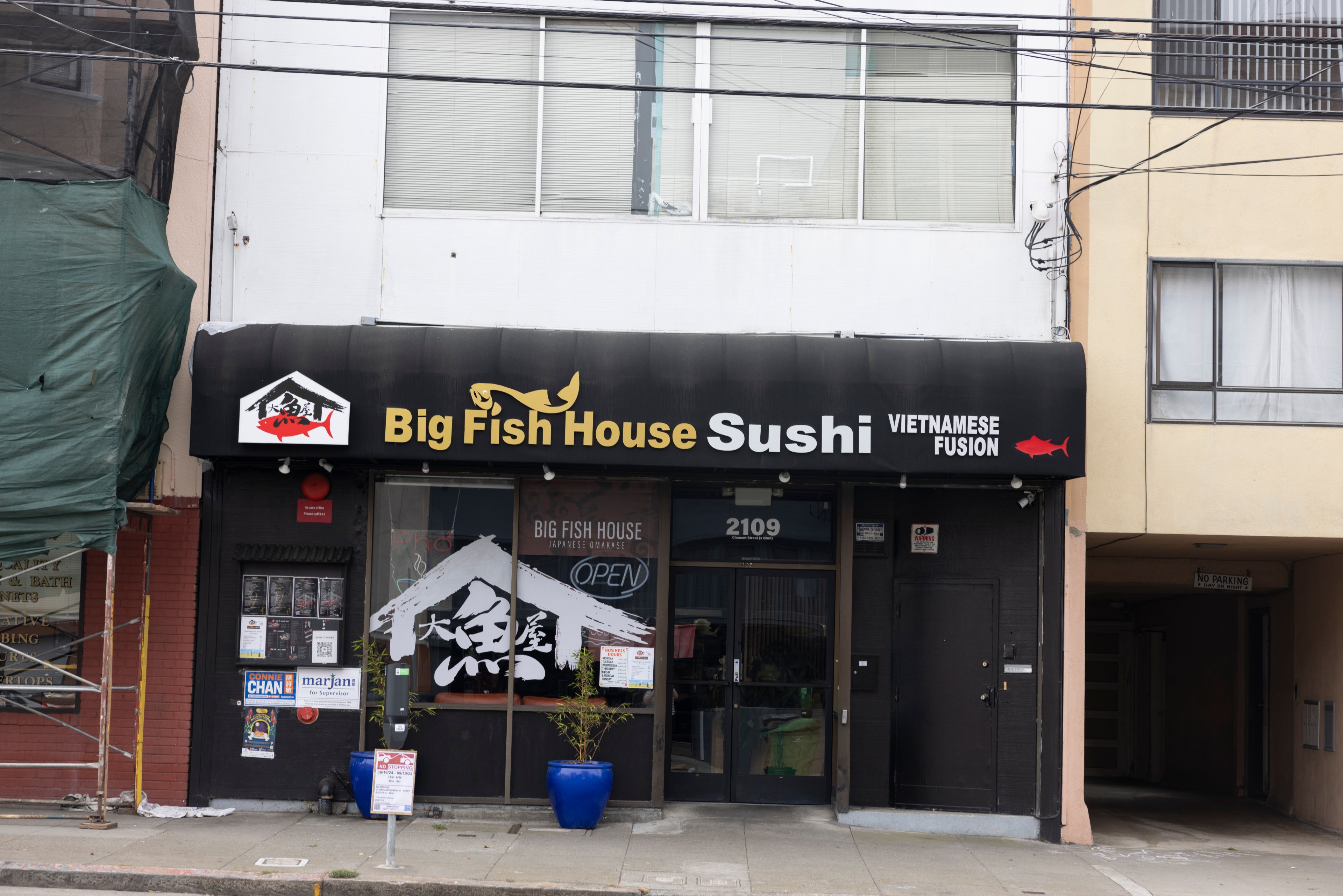 The image shows a storefront with a sign reading &quot;Big Fish House Sushi Vietnamese Fusion&quot; with a black awning. The building's address is 2109.