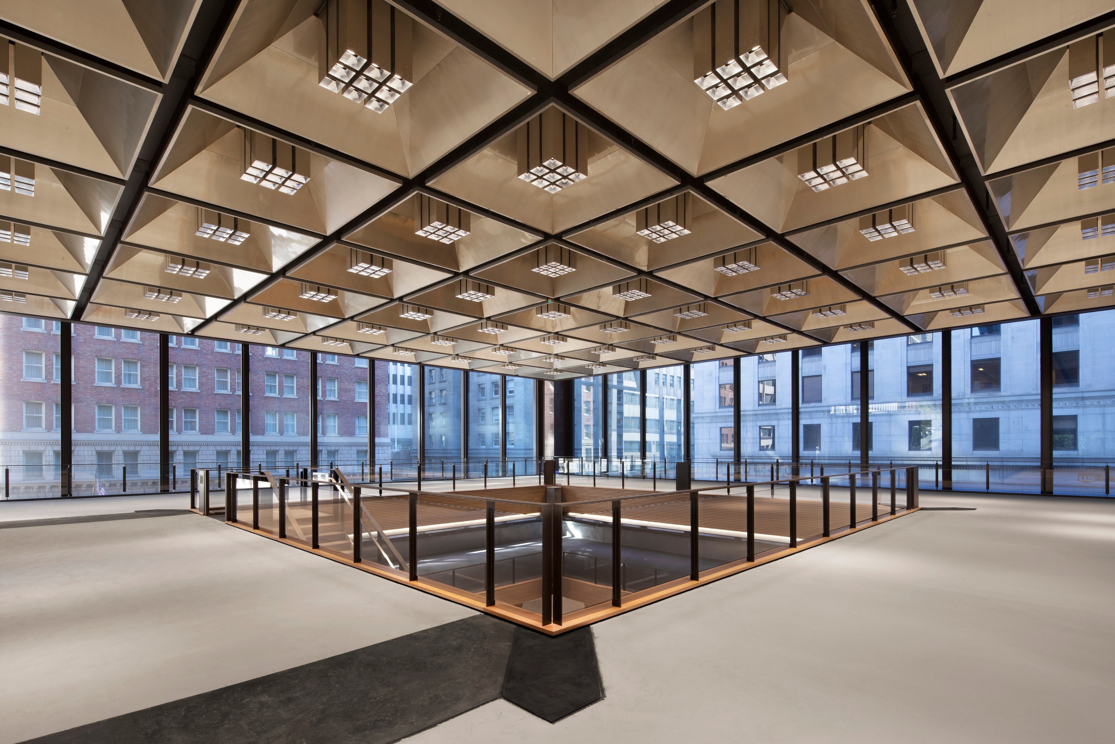 The top floor of an atrium is filled with natural light.