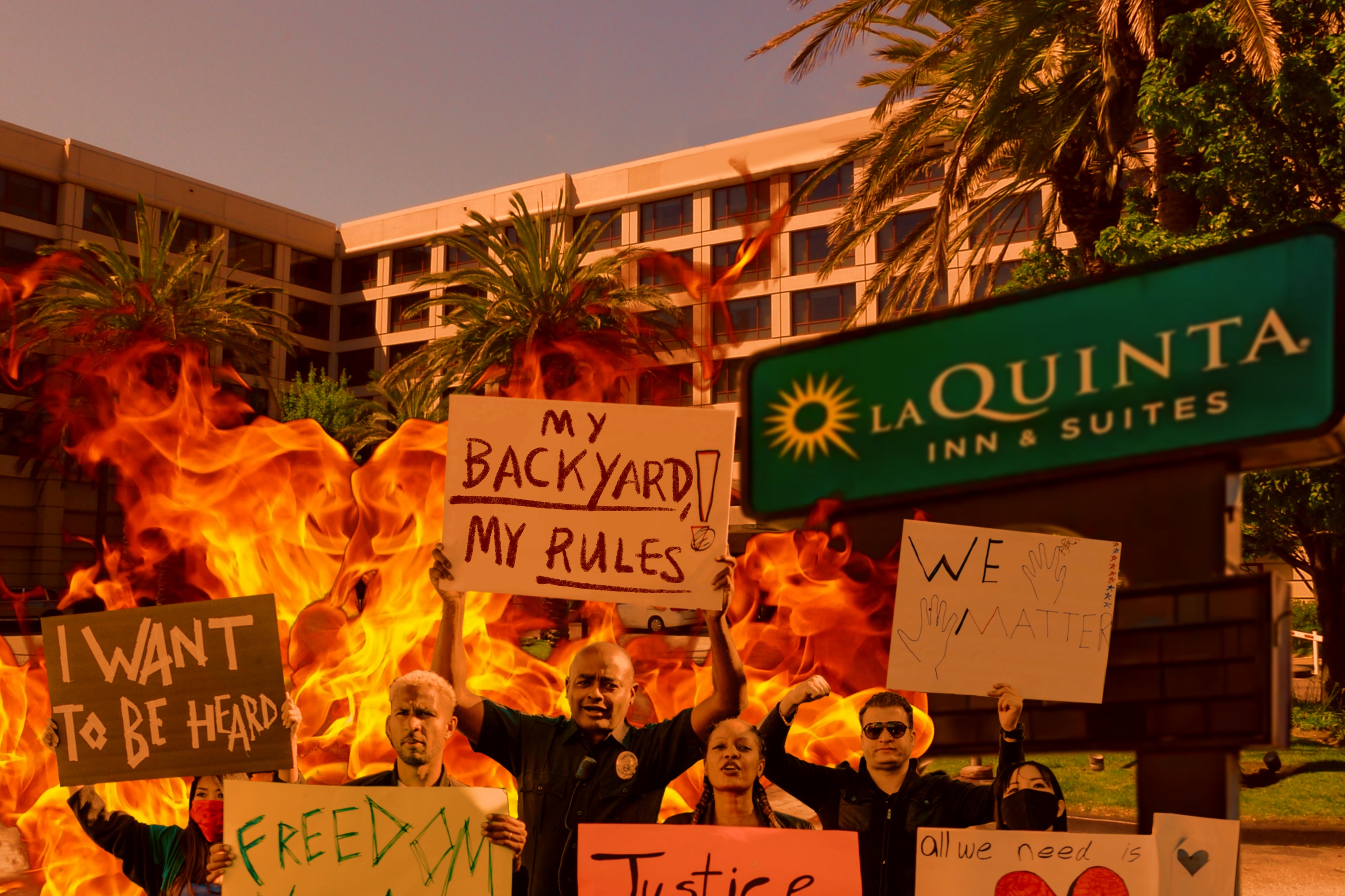 People at a protest hold signs with various messages like "My backyard, my rules" and "We matter," in front of a La Quinta Inn & Suites amidst flames.