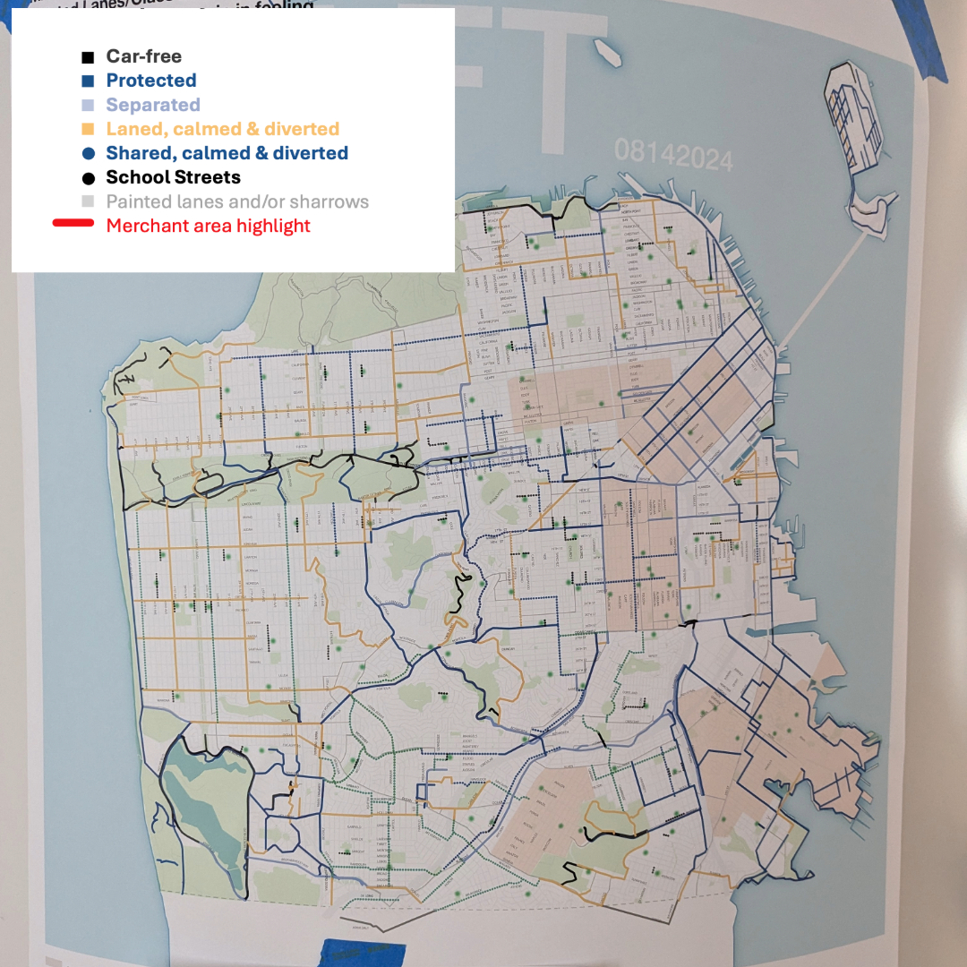 The image shows a draft map of a city with various streets marked in different colors and patterns indicating car-free areas, protected lanes, shared lanes, and merchant areas.