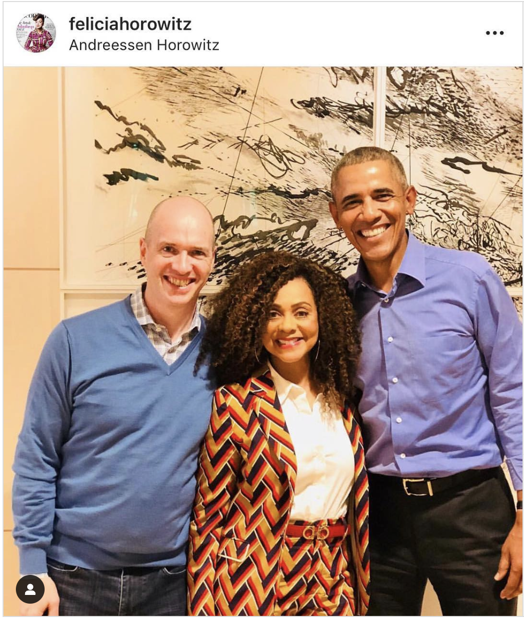 Two men and one woman posing for a picture.