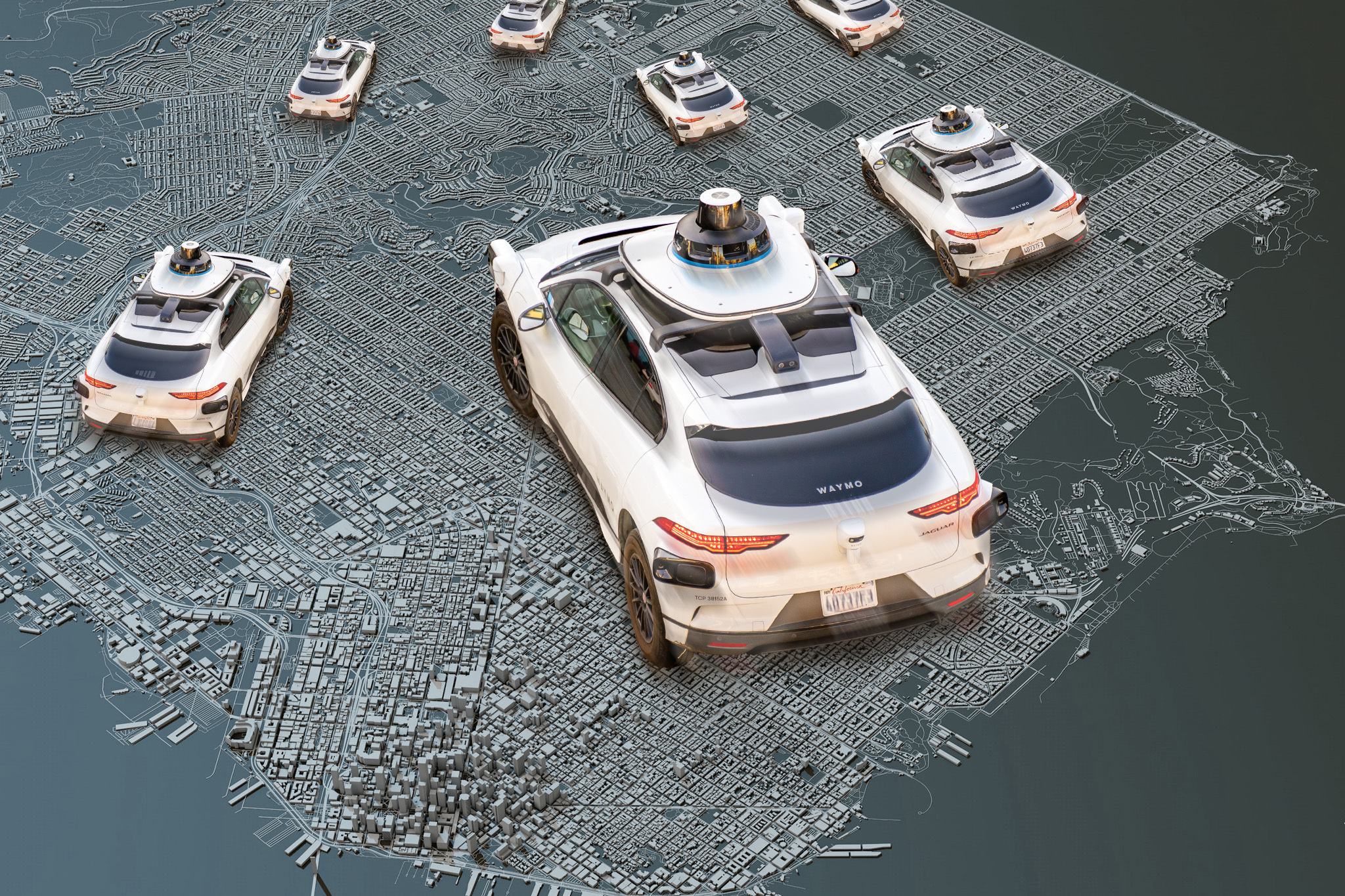 The image shows several white autonomous vehicles equipped with sensors on a detailed 3D city map. The cars appear to be navigating different routes.