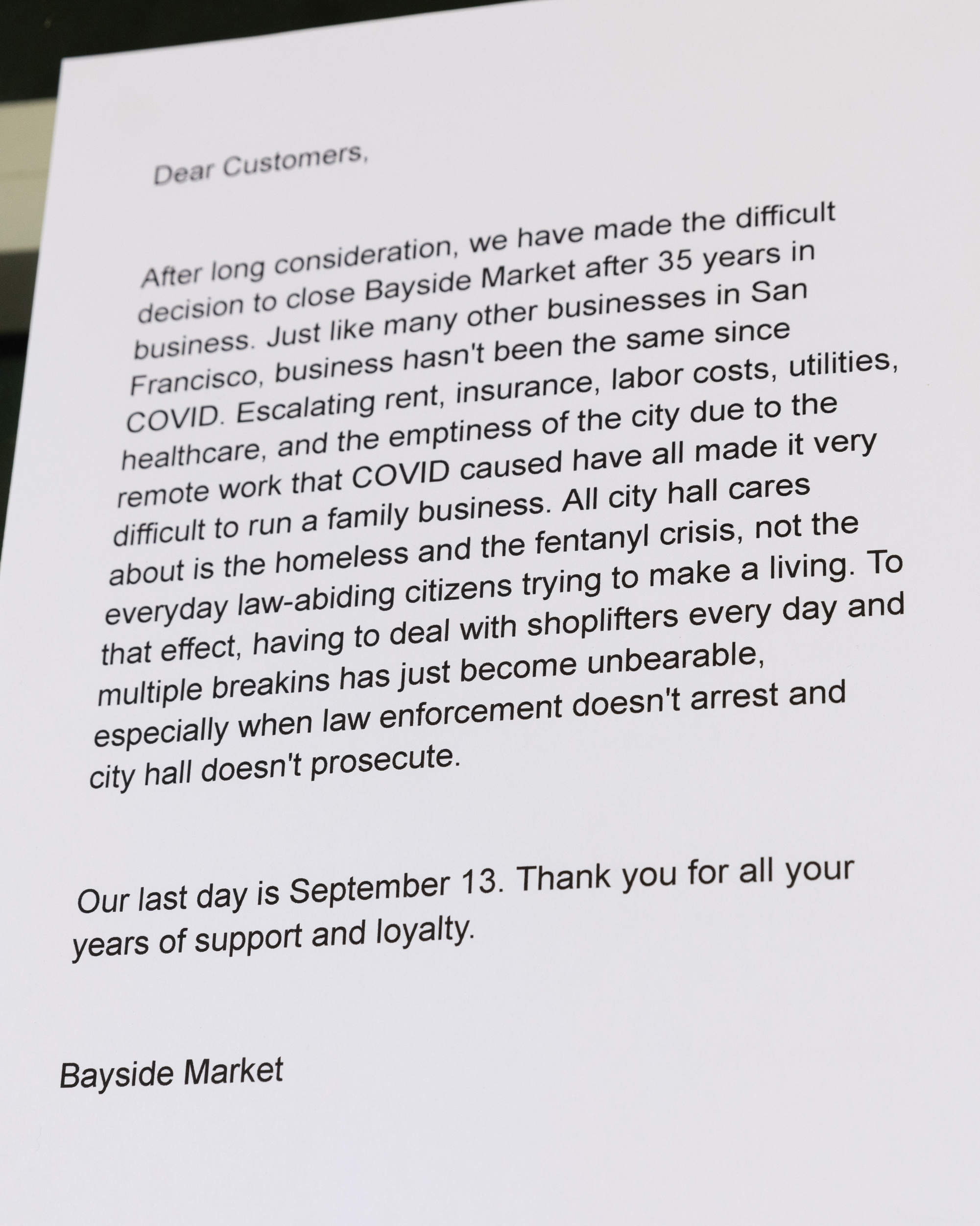 The image is a letter announcing the closure of Bayside Market after 35 years, citing challenges such as rising costs, theft, and lack of law enforcement support.