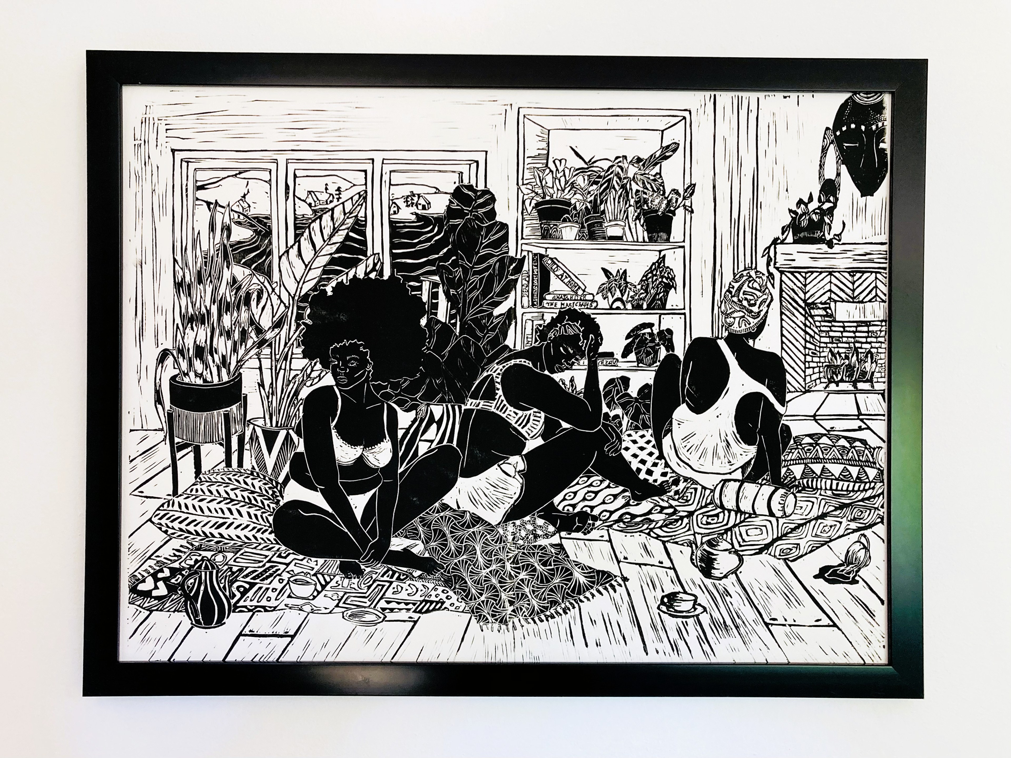 This black-and-white artwork depicts three people in an indoor setting with plants, shelves, and a fireplace, engaging in casual interaction while seated on a patterned floor.