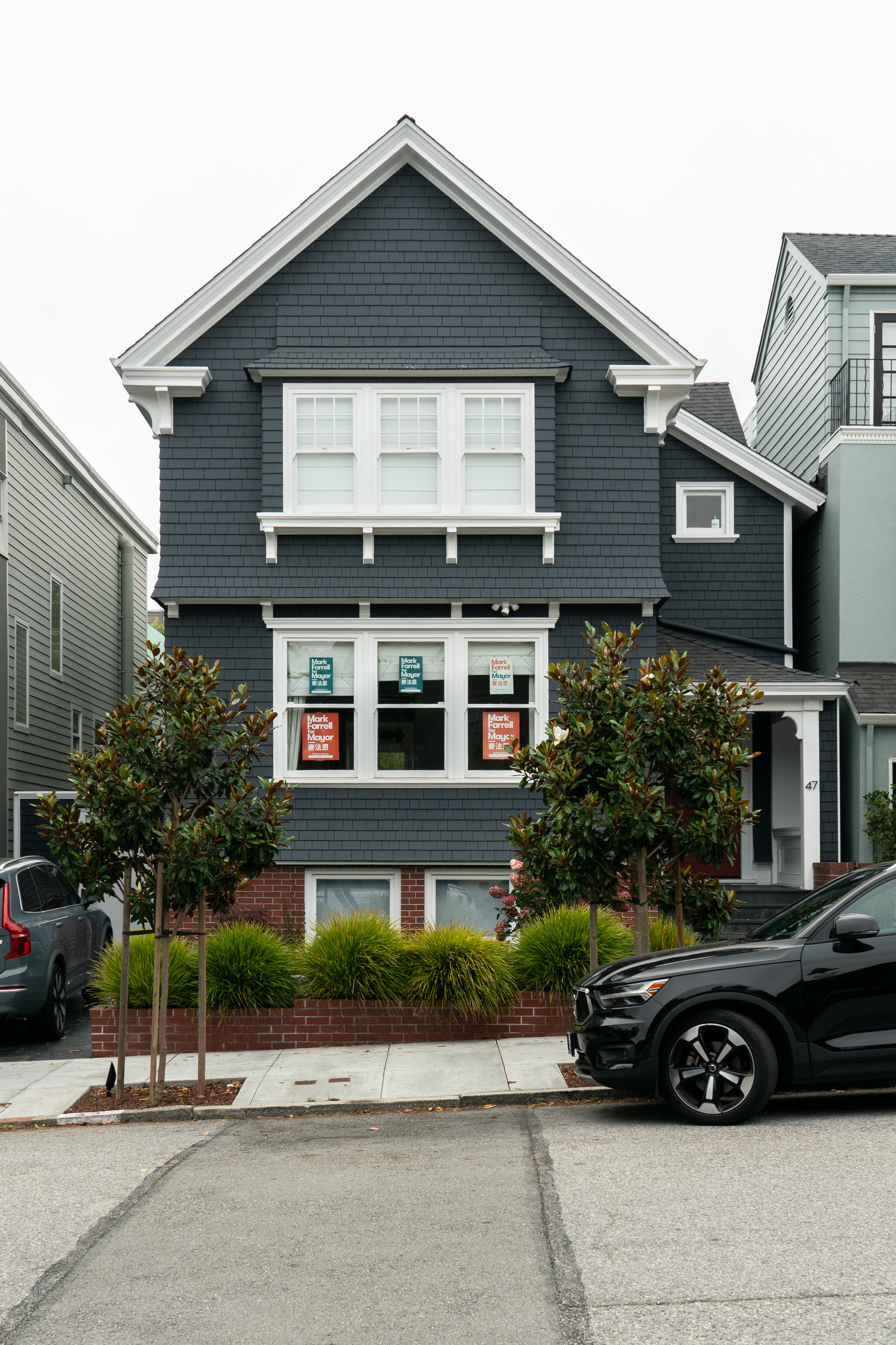 A gray house seen on a San Francisco street from the front.