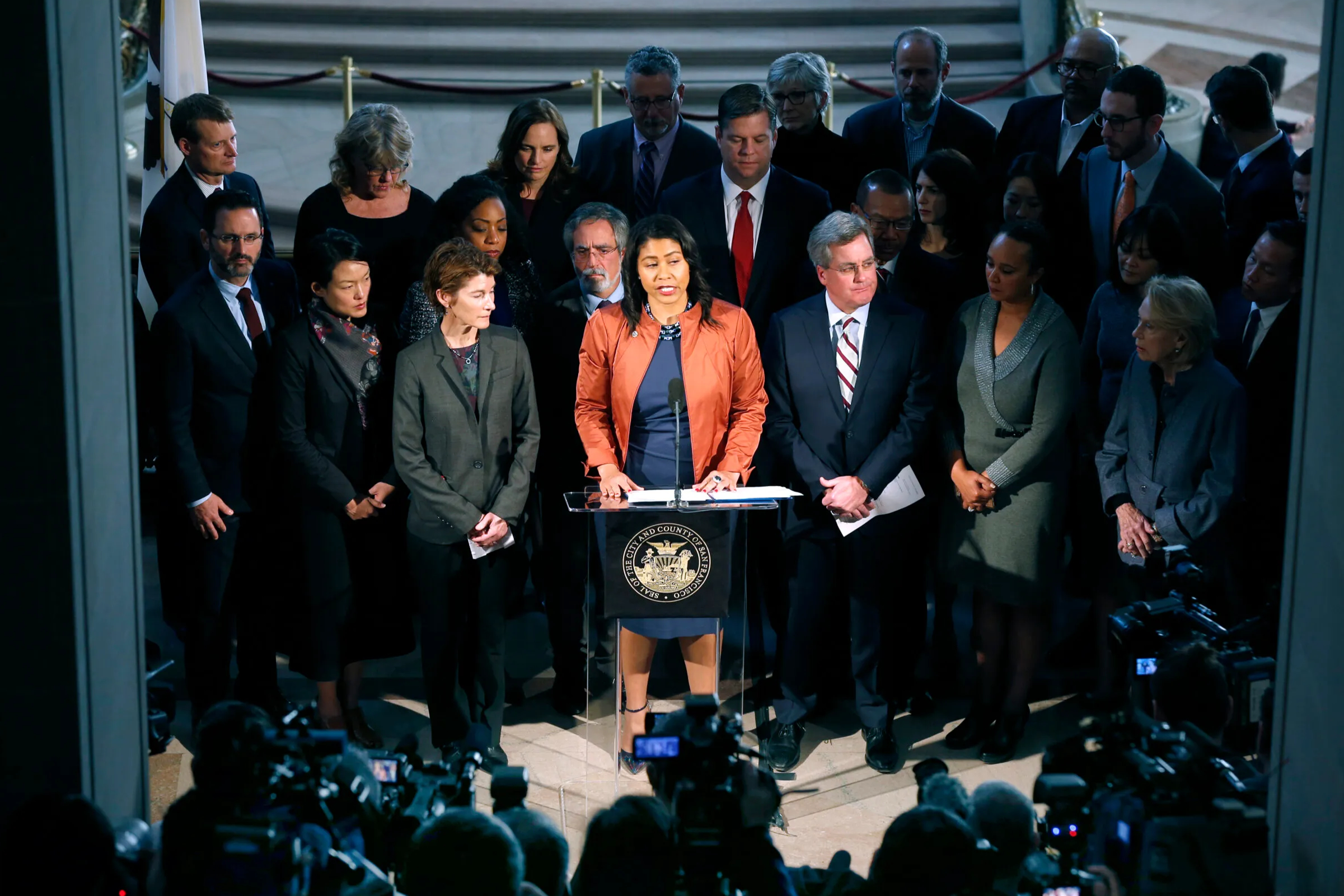 A gathering of politicians in suits with solemn expressions.